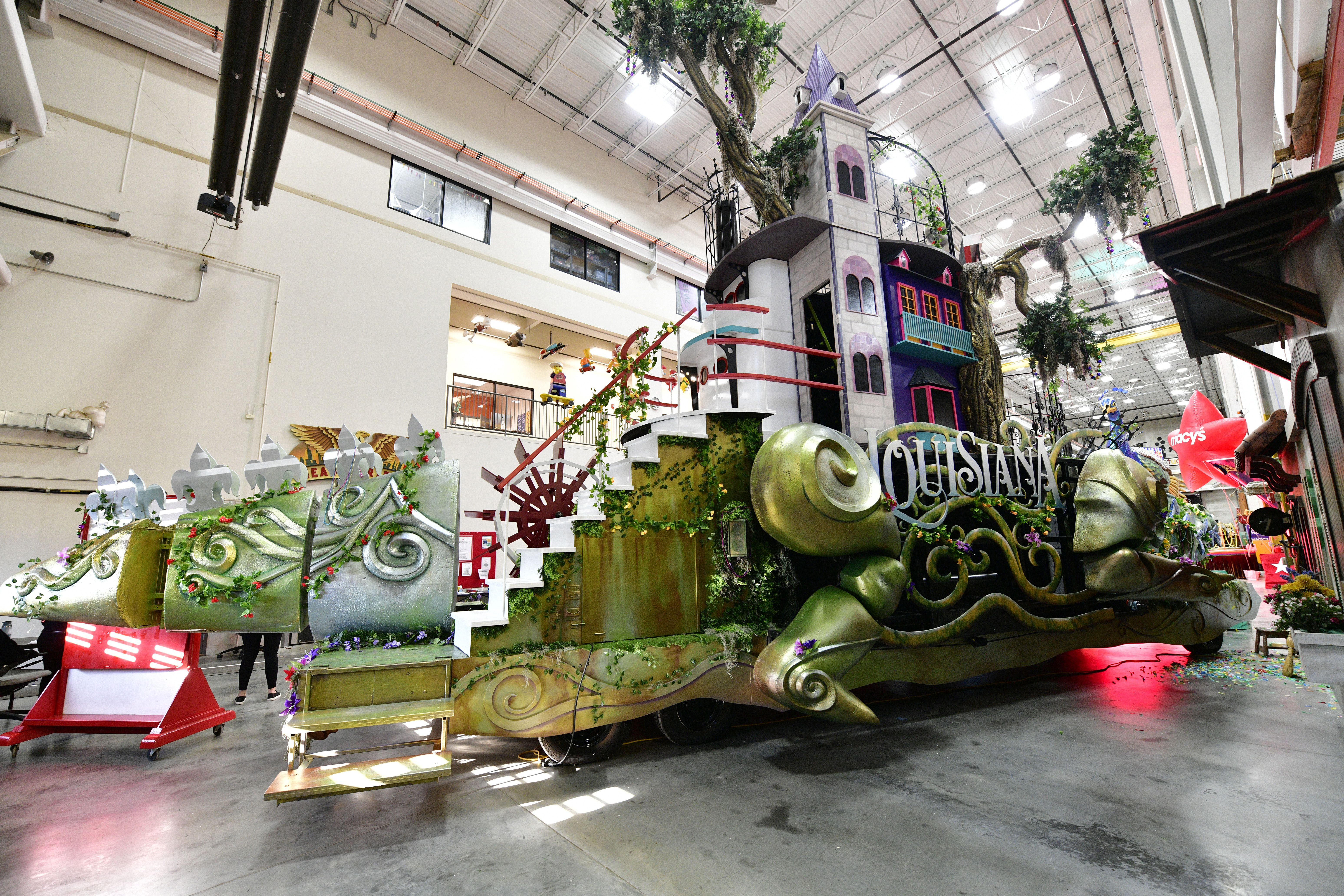 Photo shows the tail view of the Celebration Gator in the Macy's Parade. It's green and has stairs going up its spine.