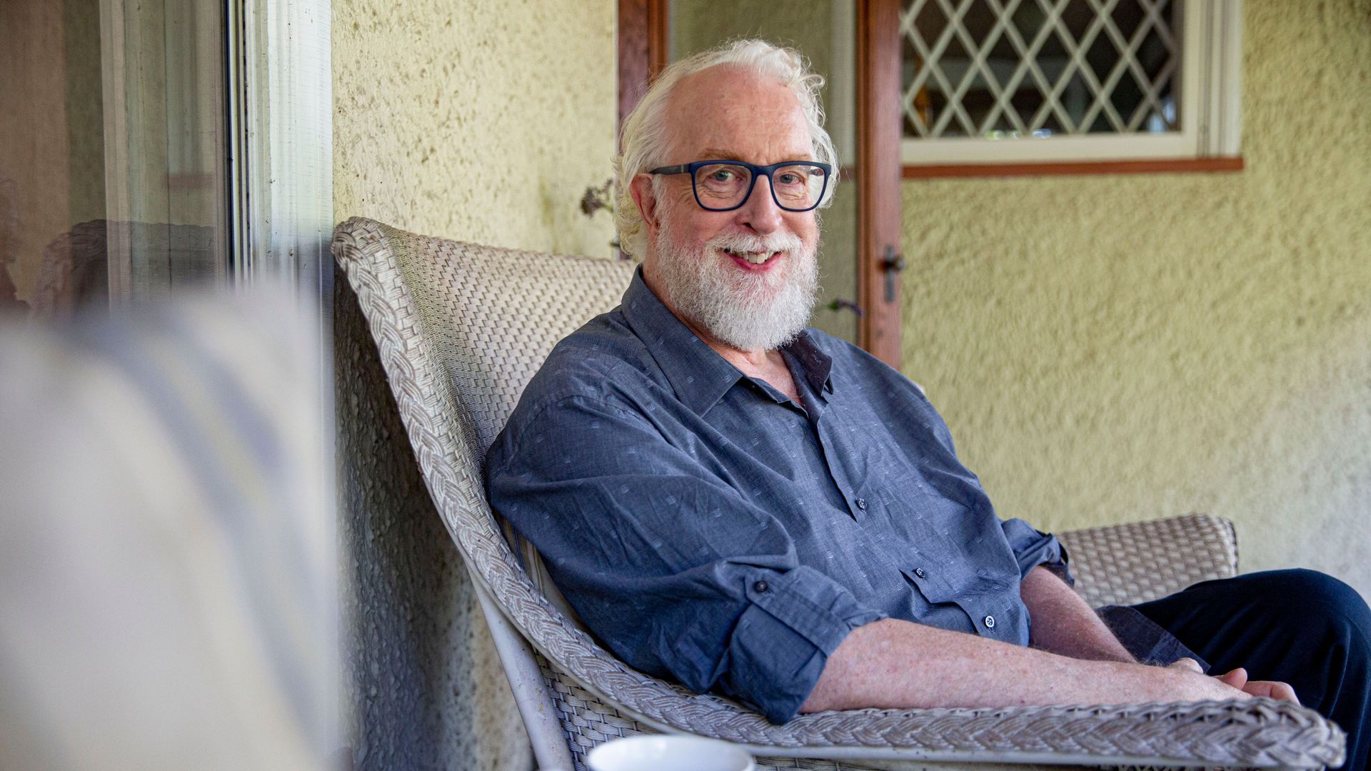 Robert Falls sits in a chair