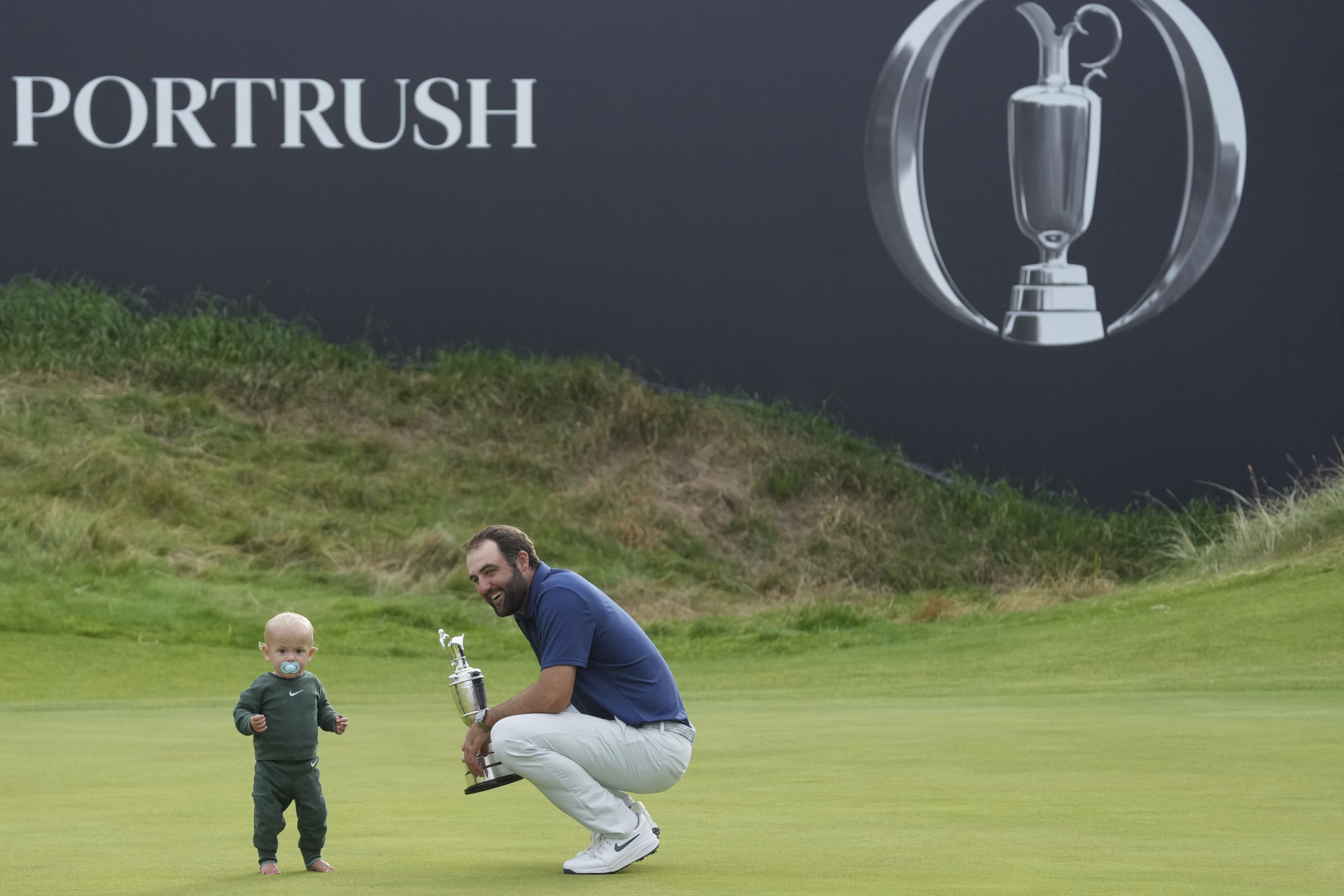Scottie Scheffler stands with his son Bennett after winning the British Open at the Royal Portrush Golf Club in Northern Ireland yesterday.