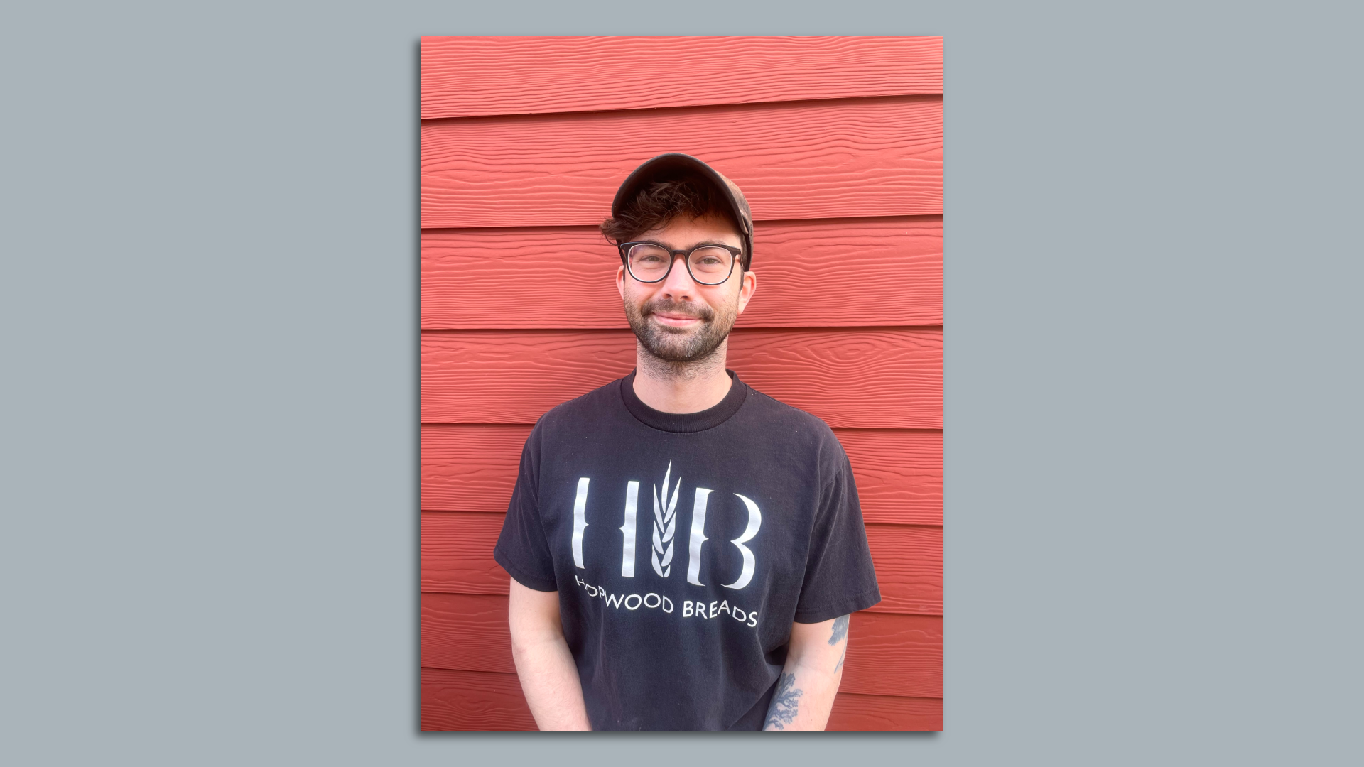A photo of a man in a black t-shirt that reads "Hopwood Breads."