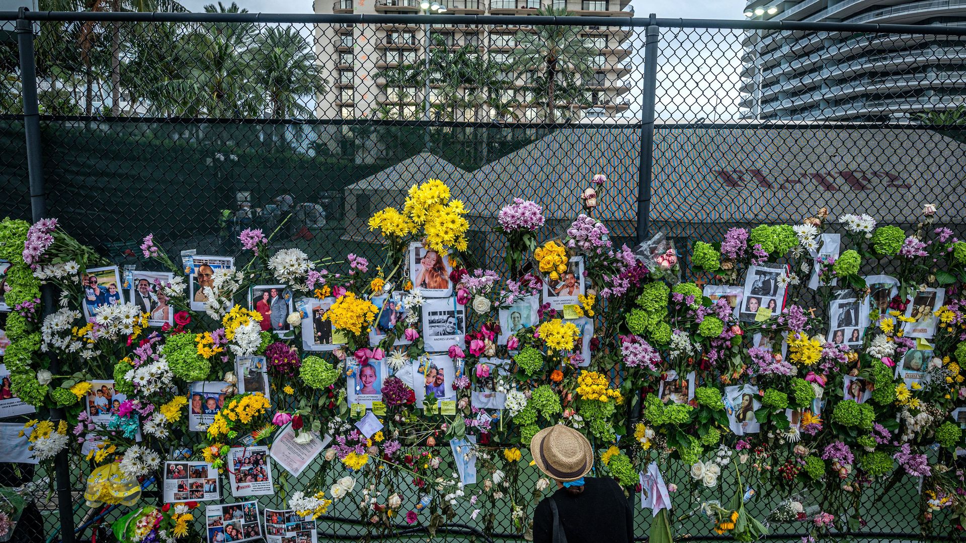 A man looks at a makeshift memorial for the missing and confirmed dead in the Surfside, Florida, building collapse.