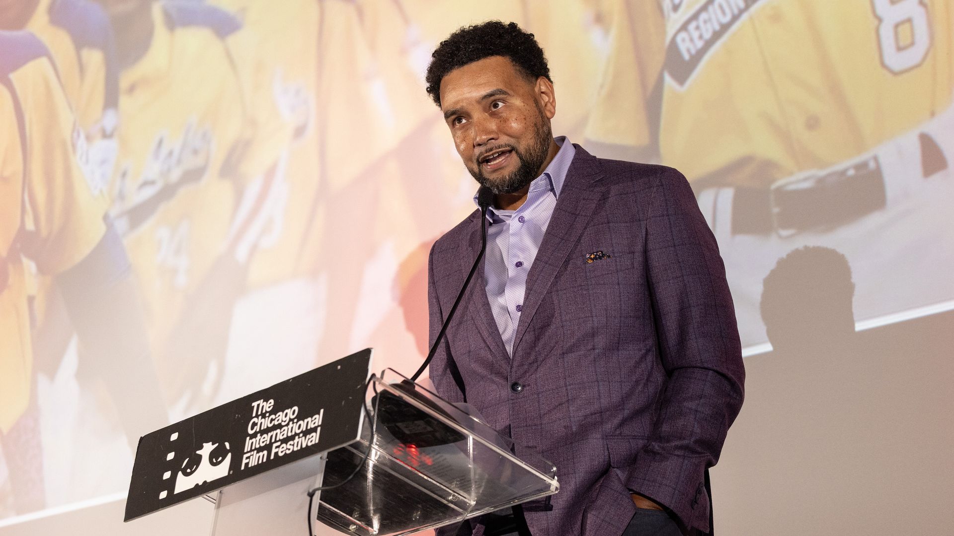 Director Kevin Shaw at a clear podium with a black sign that reads: The Chicago Film Festival 