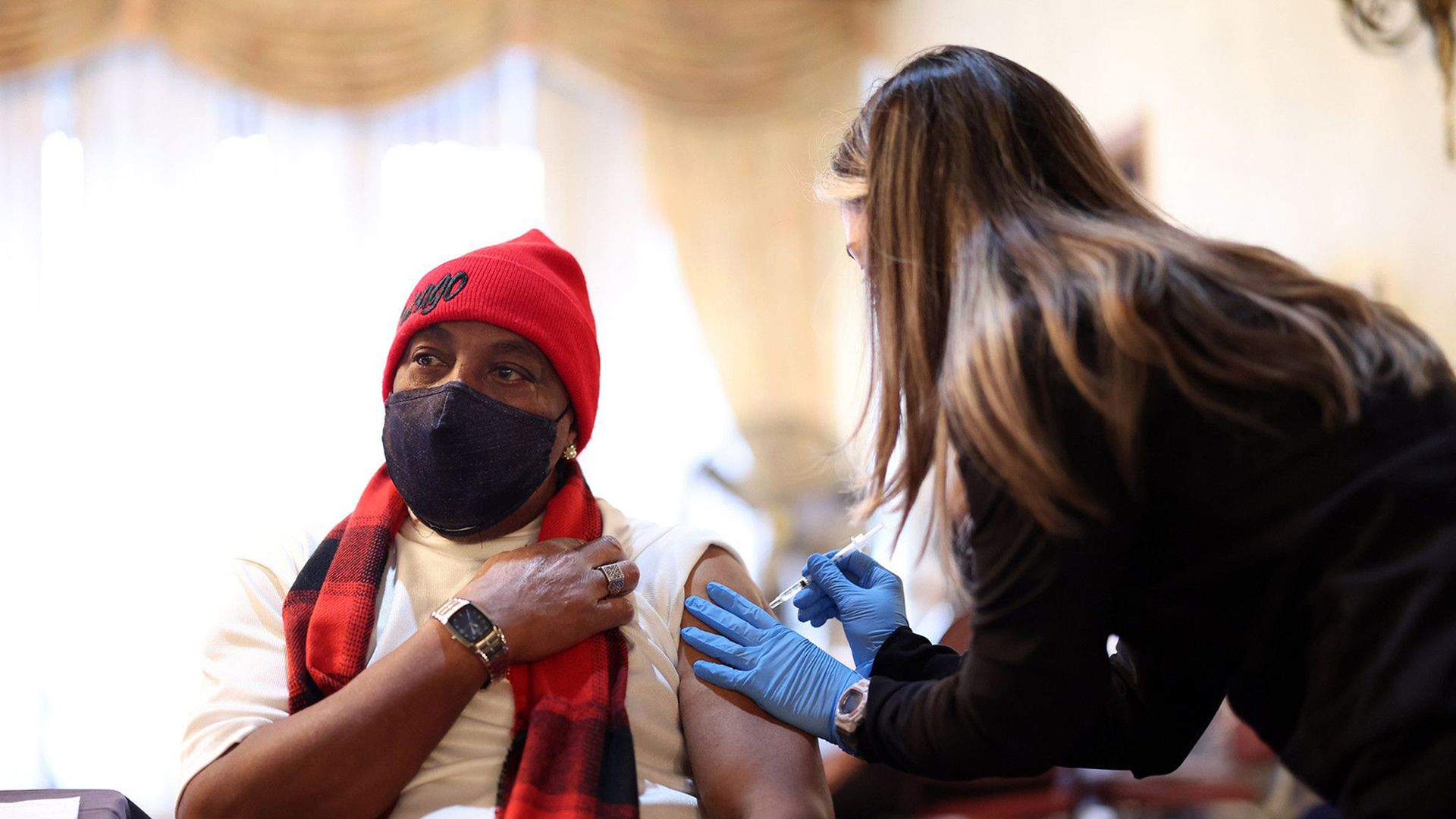 Photo of a man getting a vaccine. 