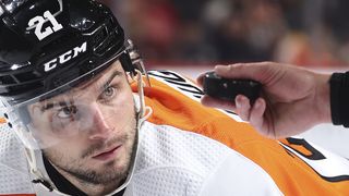 Philadelphia Flyers' Scott Laughton watches as the puck is dropped by a referee. 