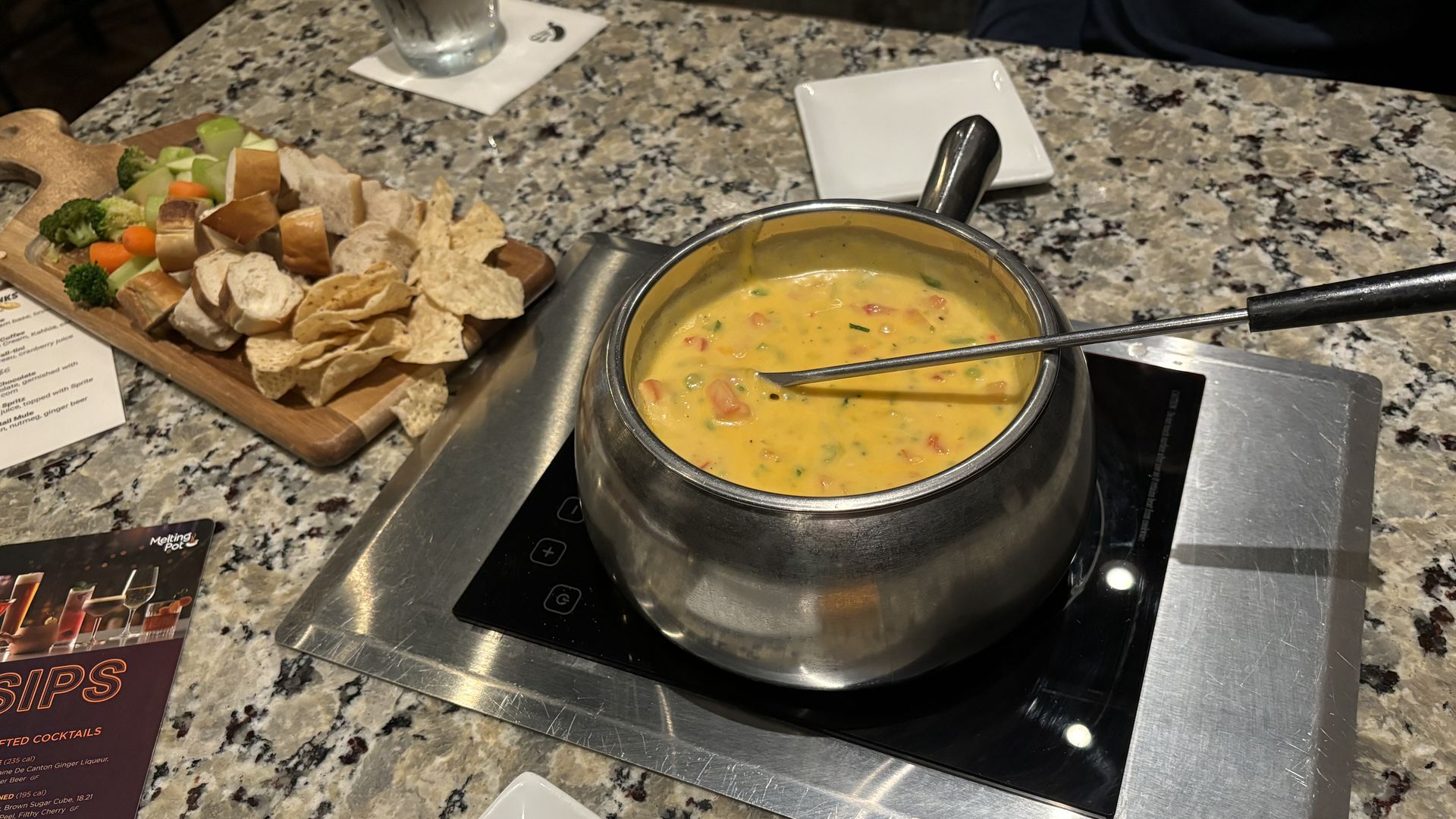 A fondue pot with cheese in it