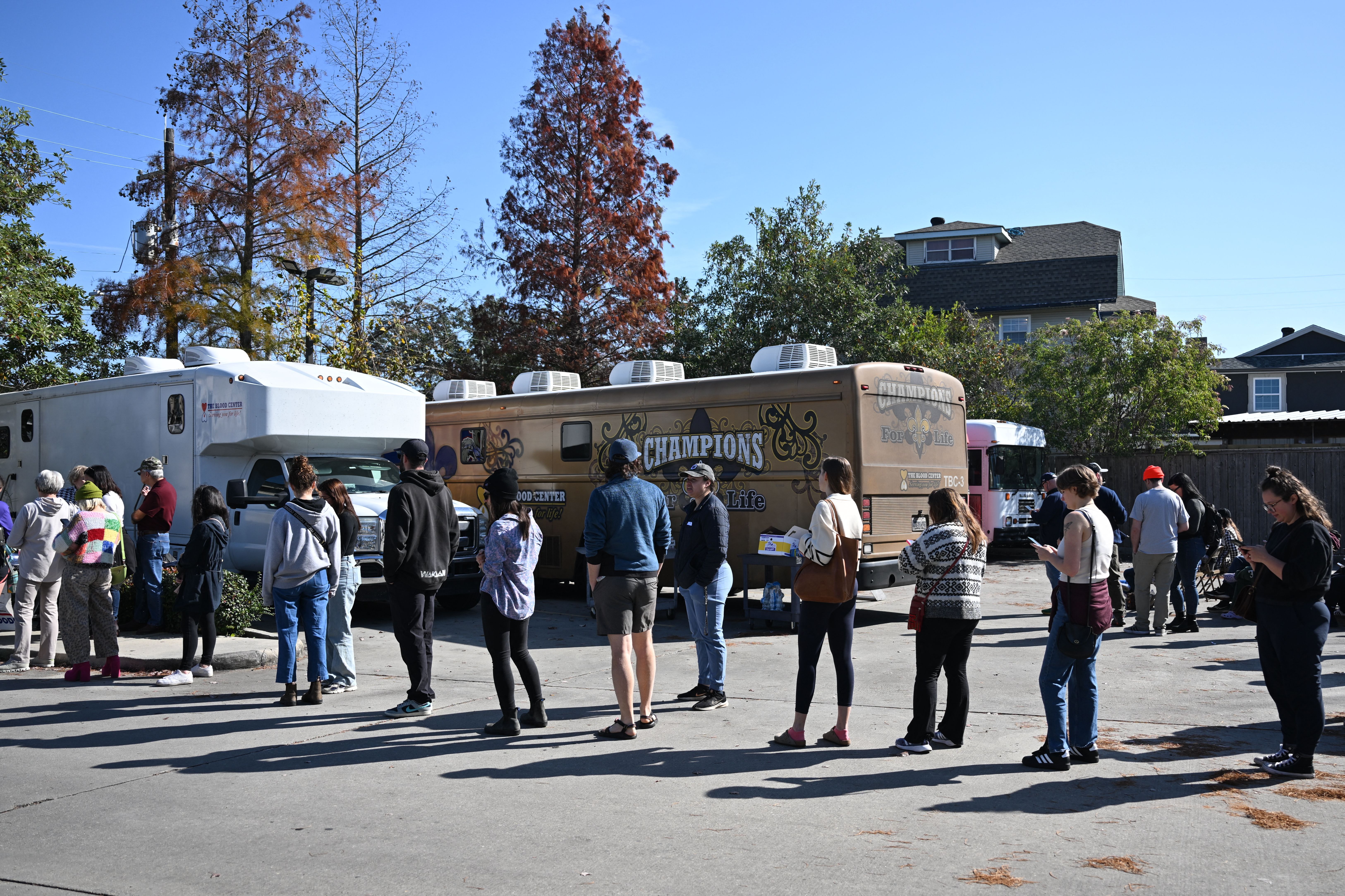 Photo shows people waiting in line to donate blood.