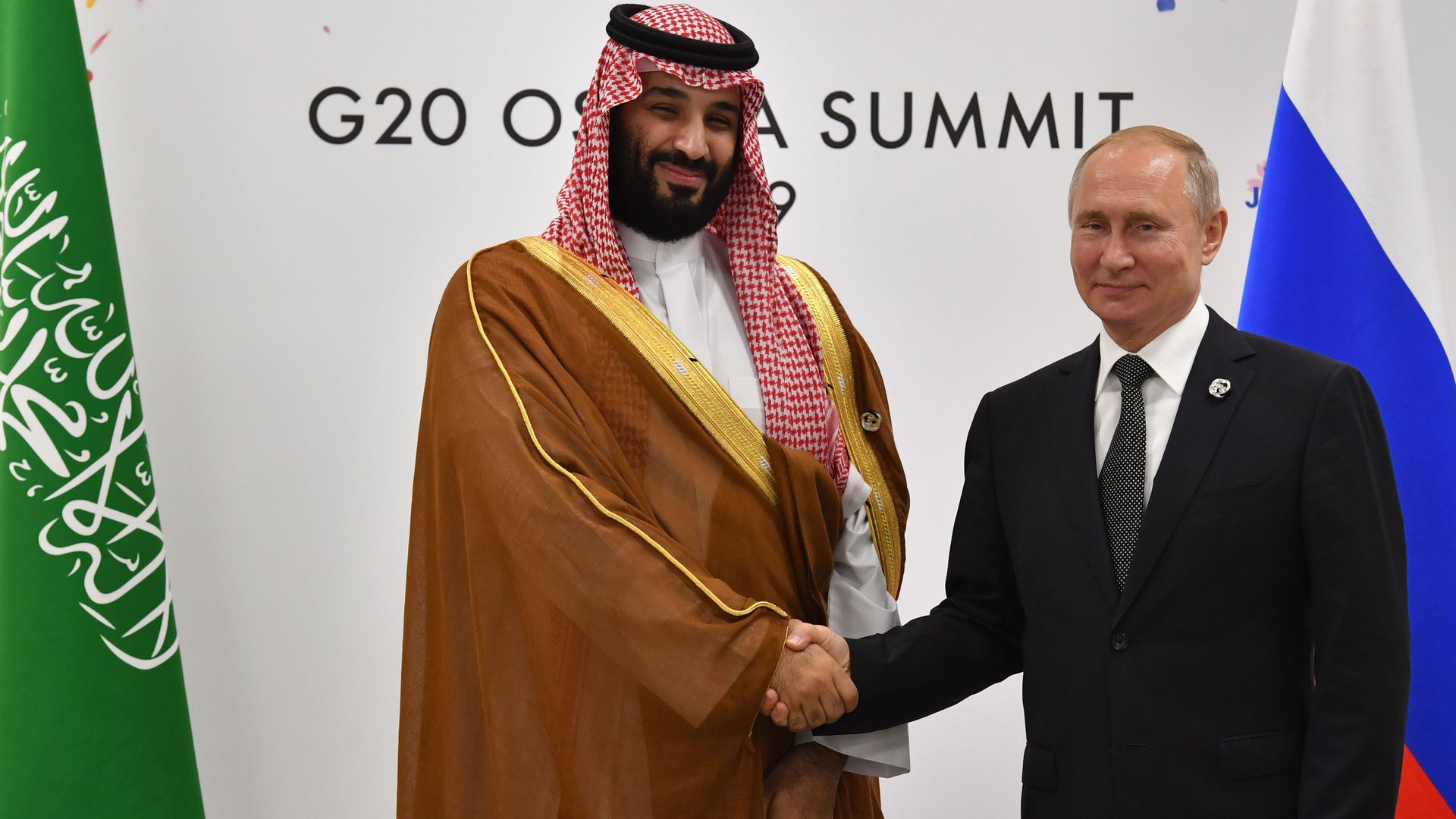 Russia's President Vladimir Putin (R) shakes hands with Saudi Arabia's Crown Prince Mohammed bin Salman during a meeting on the sidelines of the G20 Summit