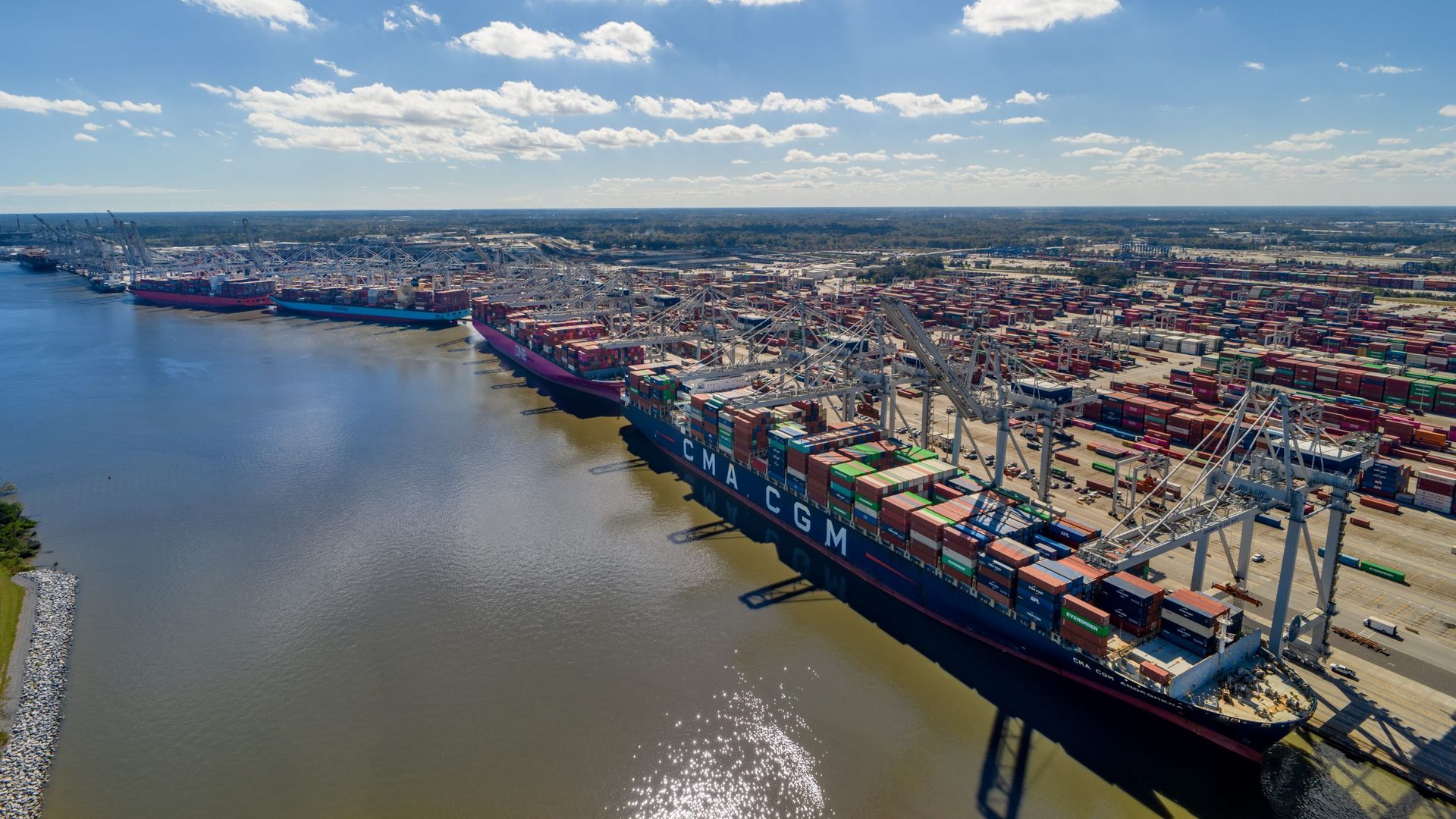 Image of the rapidly growing Port of Savannah, with many freighters and containers lined up. 
