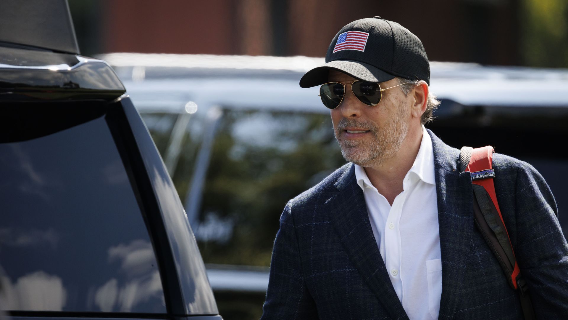 Hunter Biden wearing a cap with an American flag on it.