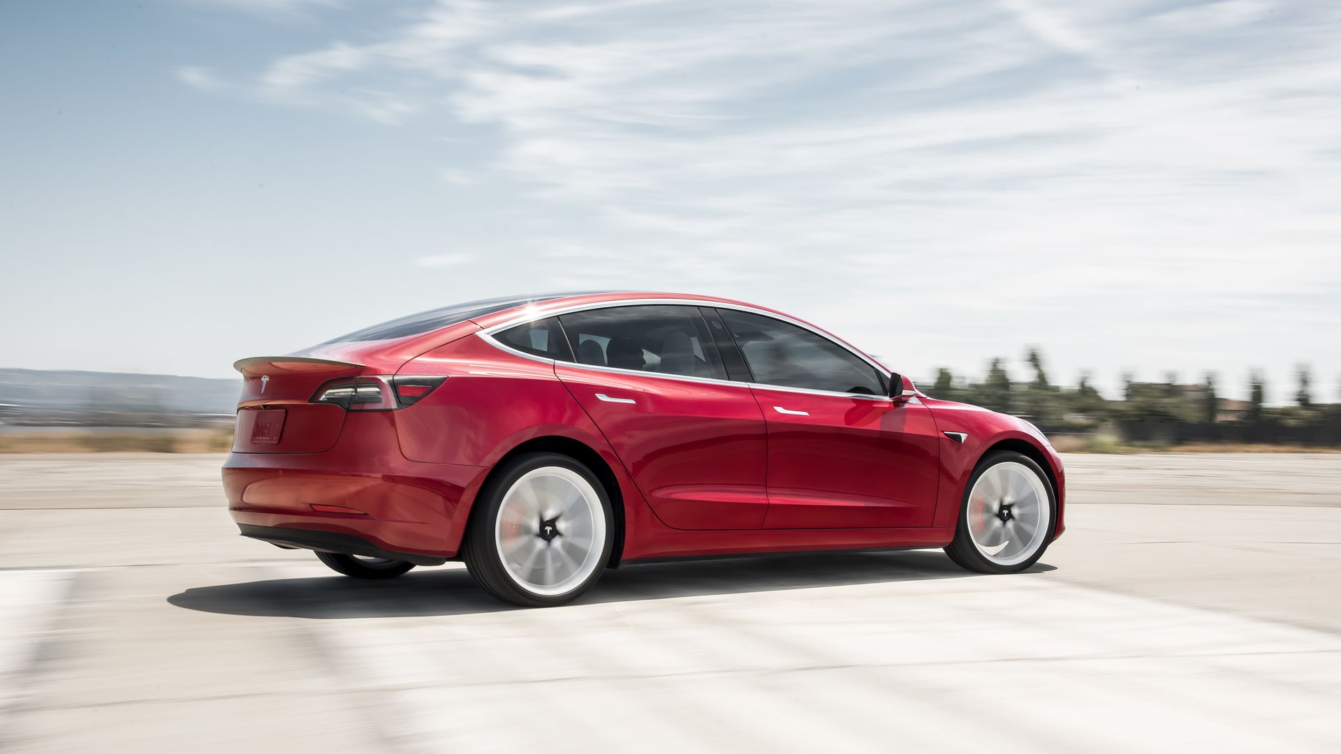 Image of a red Tesla Model 3