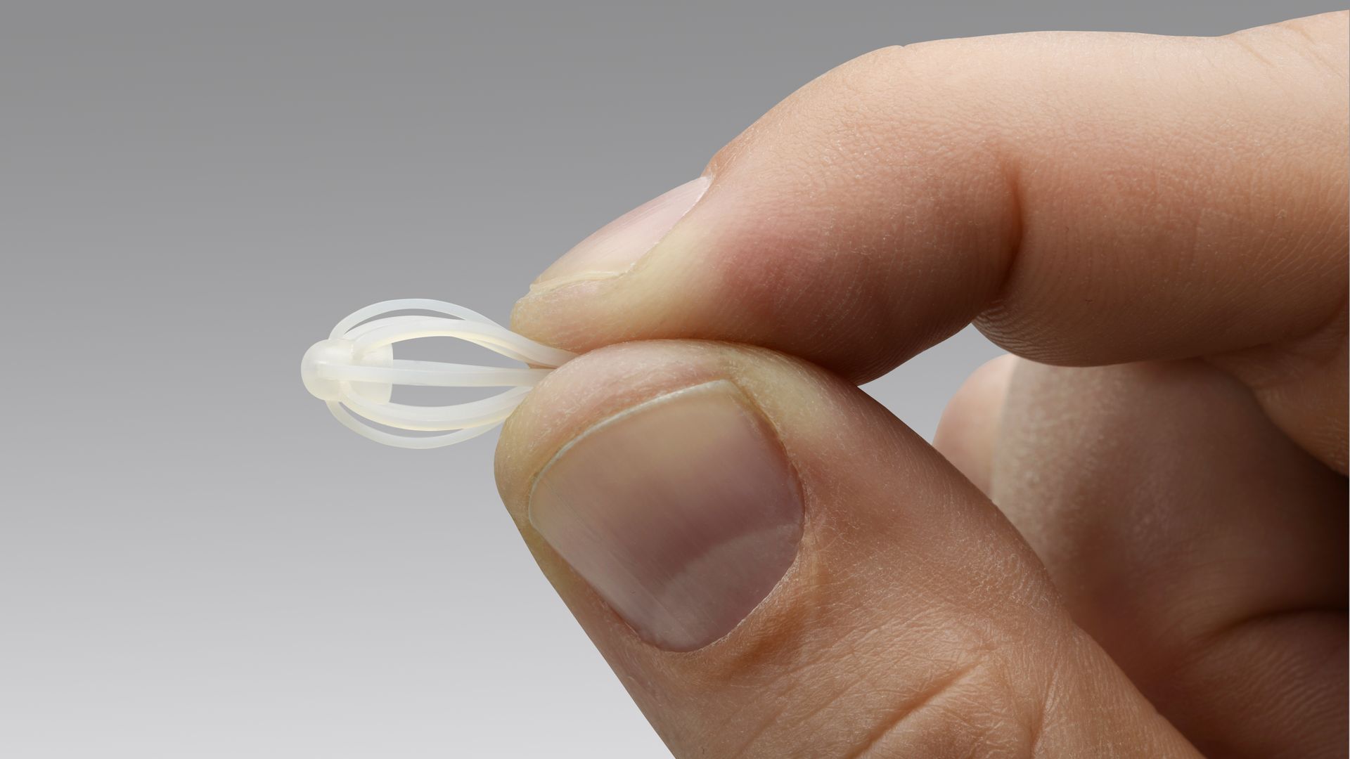 A person holding the small Sinuva drug device.