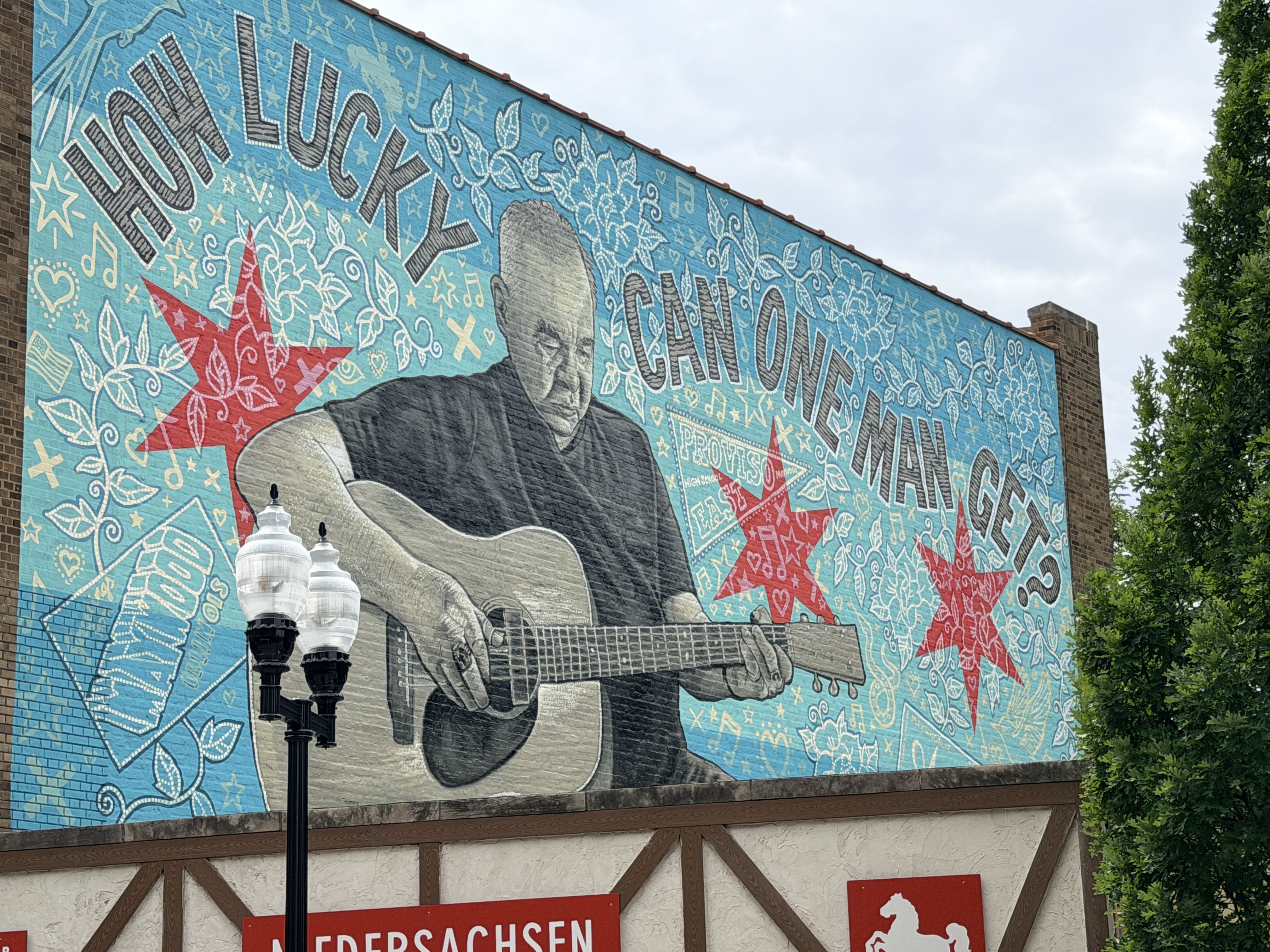 Mural of a man playing a guitar