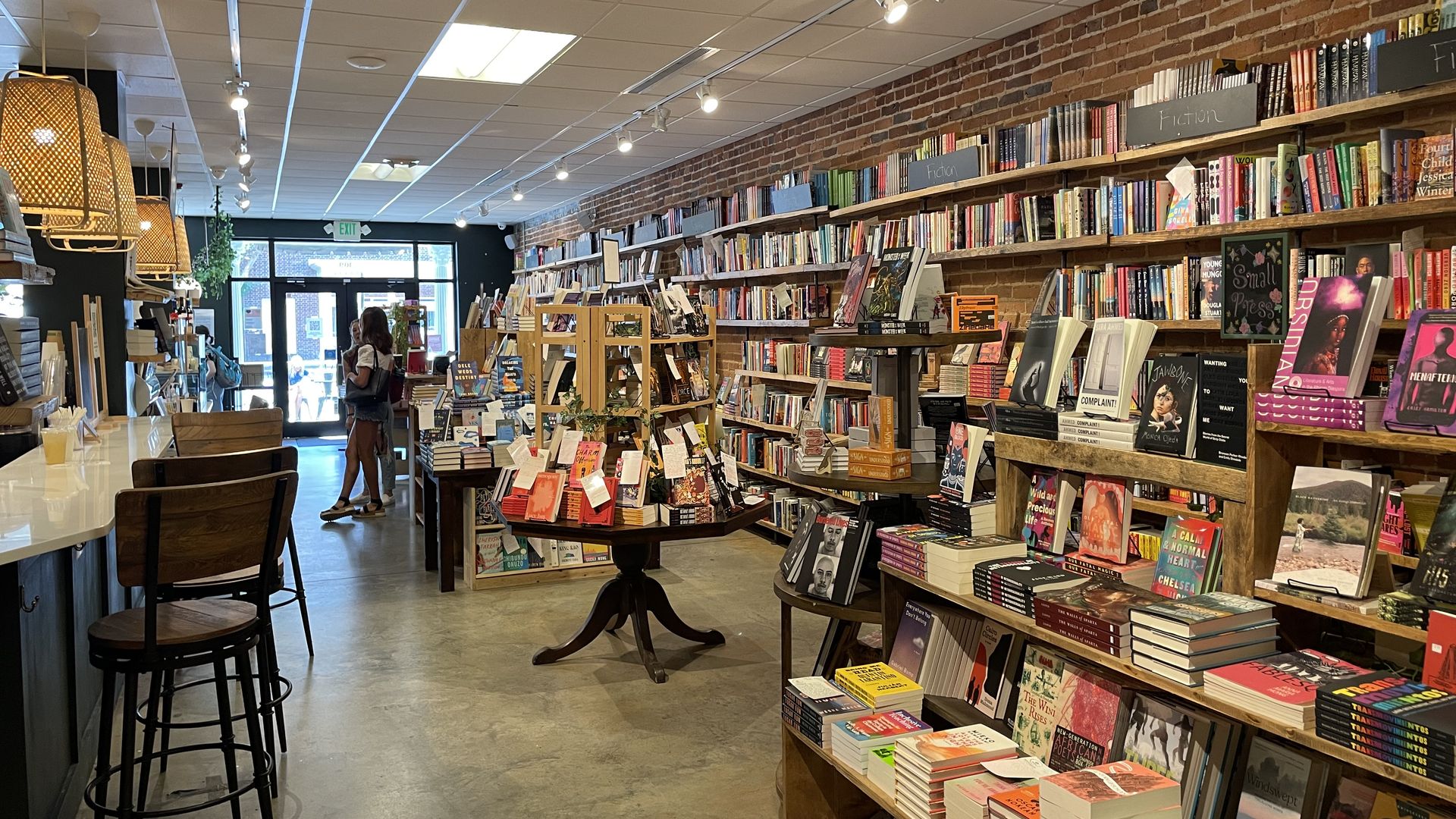 The inside of a bookstore with several display stands. 