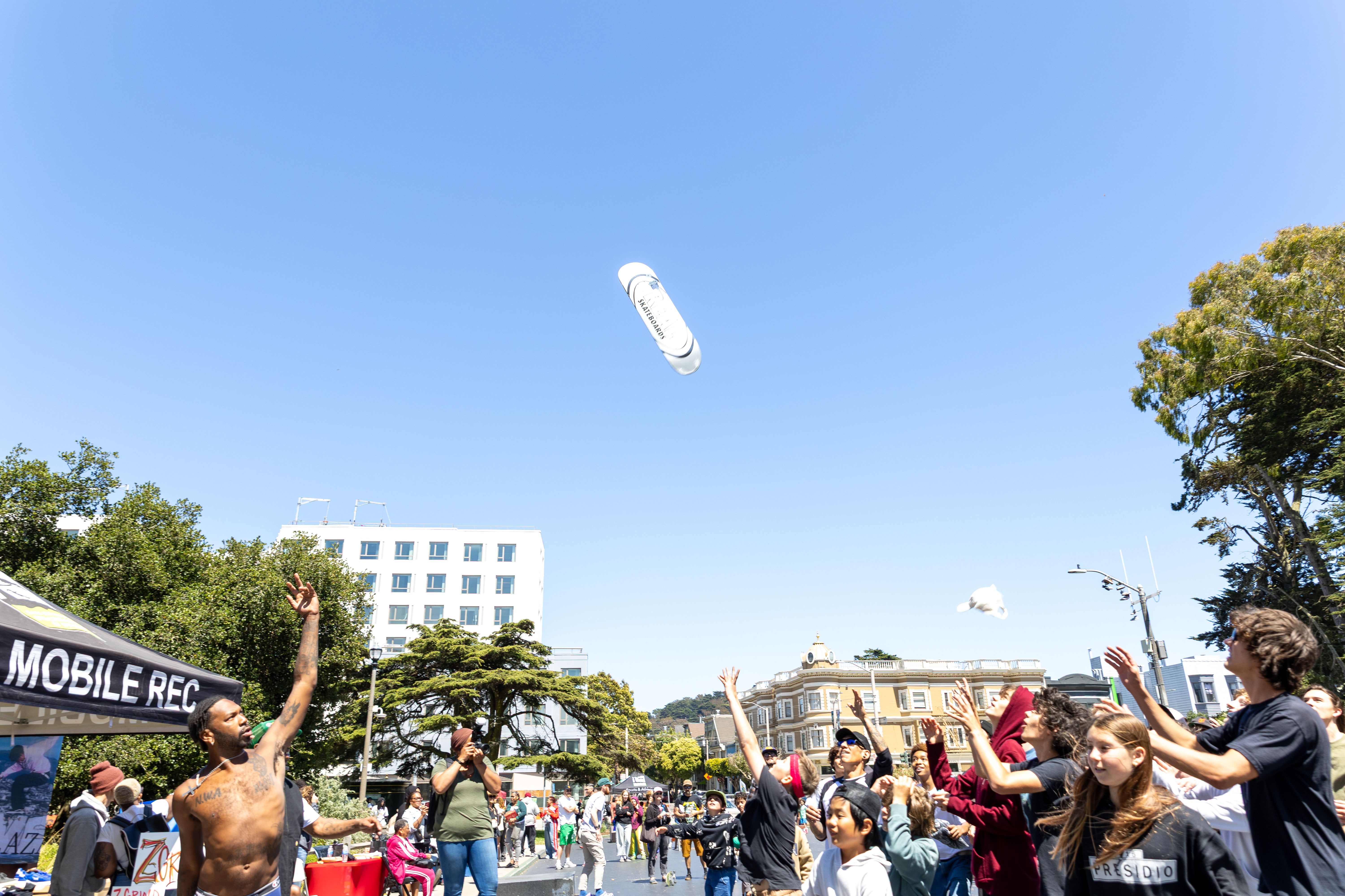 Photo of a skateboard being tossed in the air