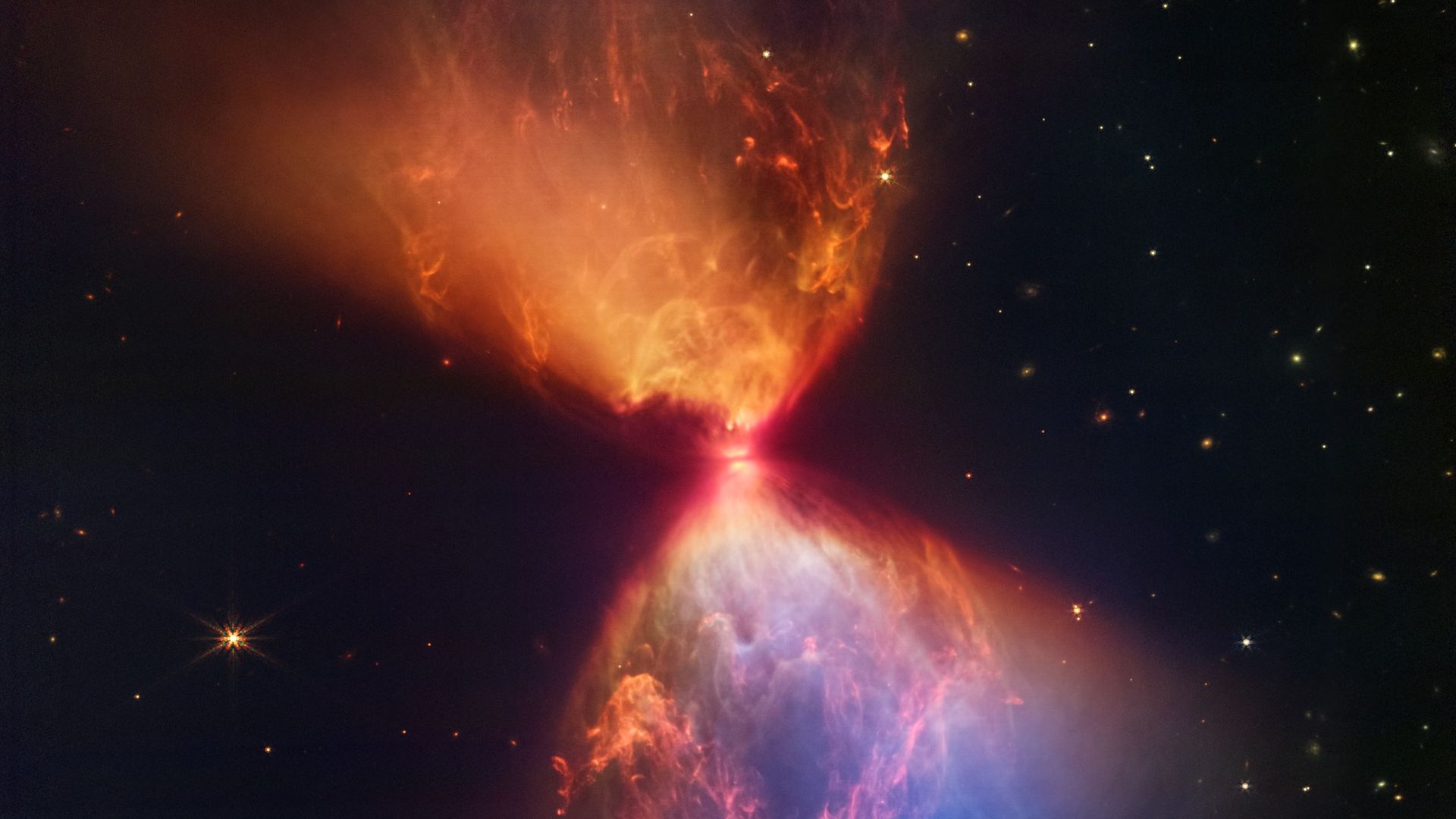 An hourglass-shaped object in space formed by a protostar and gas swirling around it.