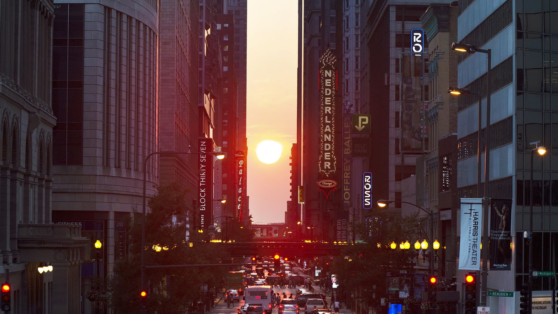 Photo of the sun setting between buildings 