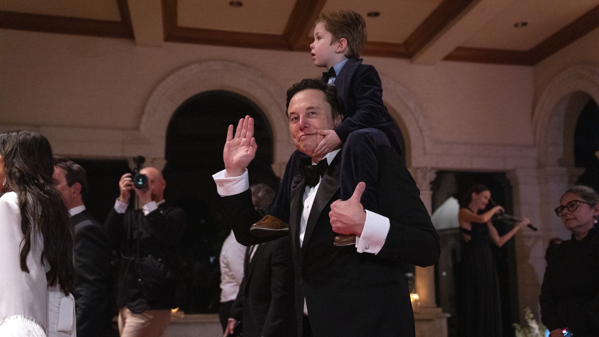 Elon Musk and his son, X AE A-Xii, arrive to a New Year's Eve party hosted by President-elect Donald Trump at Mar-a-Lago, Tuesday, Dec. 31, 2024, in Palm Beach, Fla. (AP Photo/Evan Vucci)