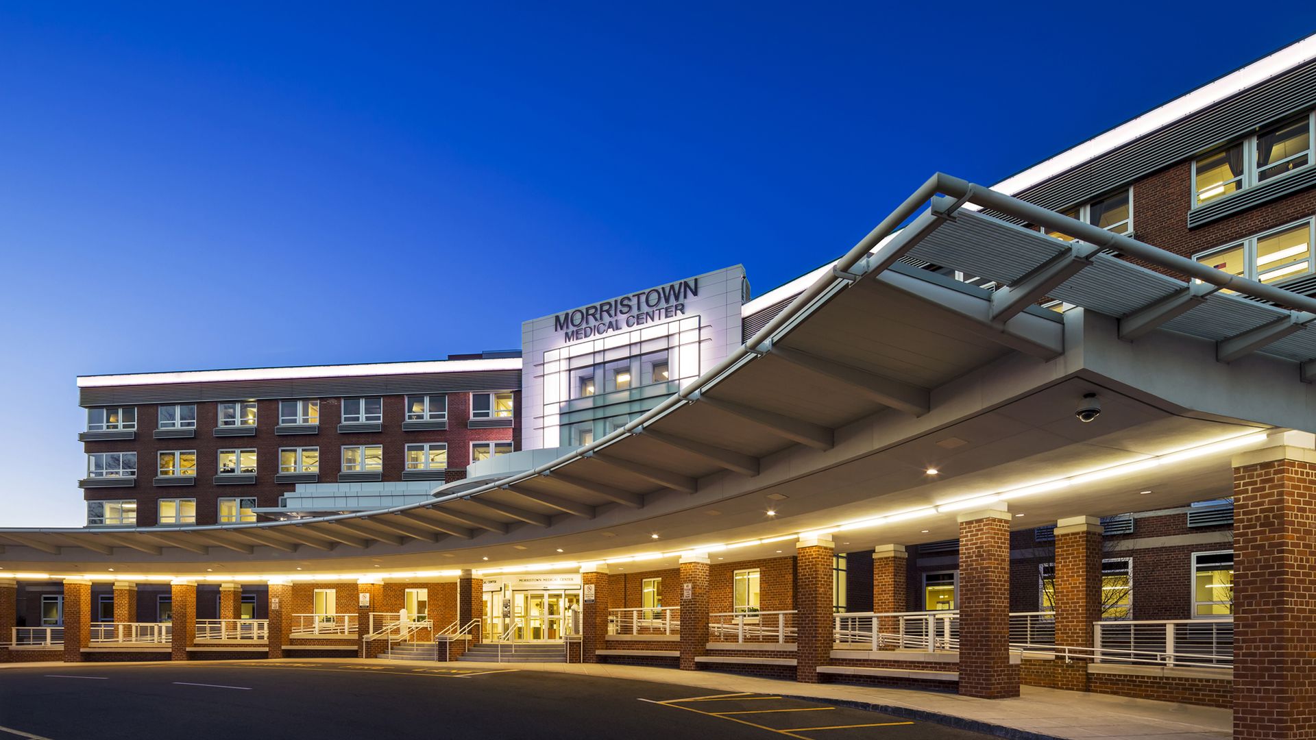 Morristown Medical Center hospital building lit up in the evening.