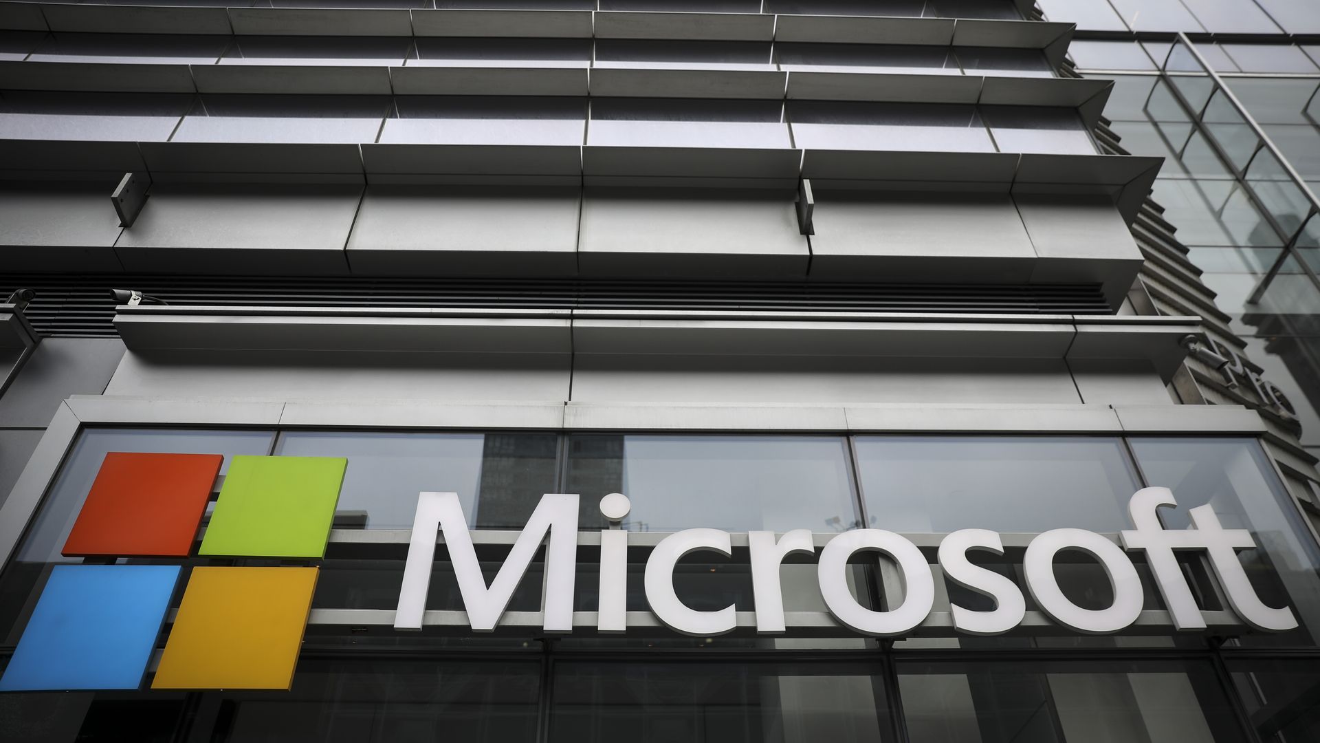 Microsoft name and Windows logo on side of a modern office building