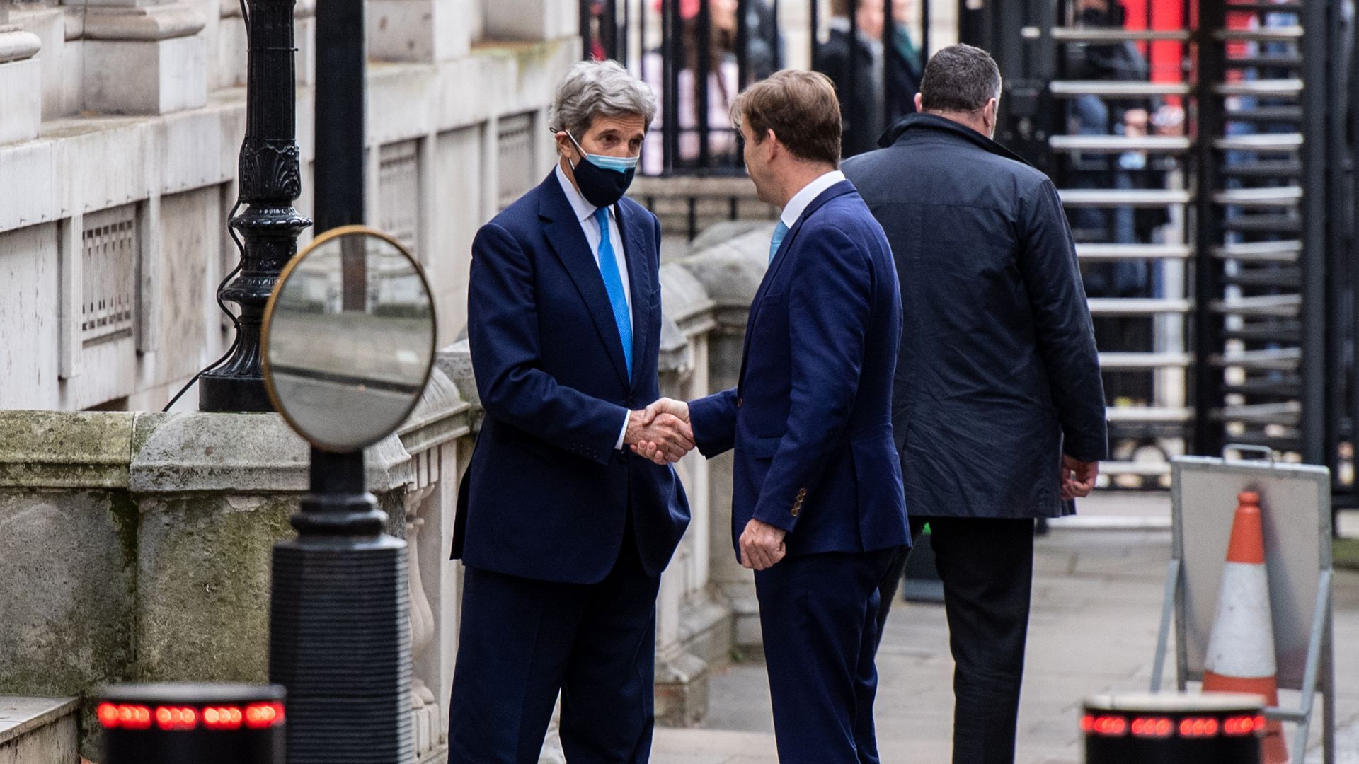 Image of John Kerry shaking British MP Tobias Elwood's hand. 