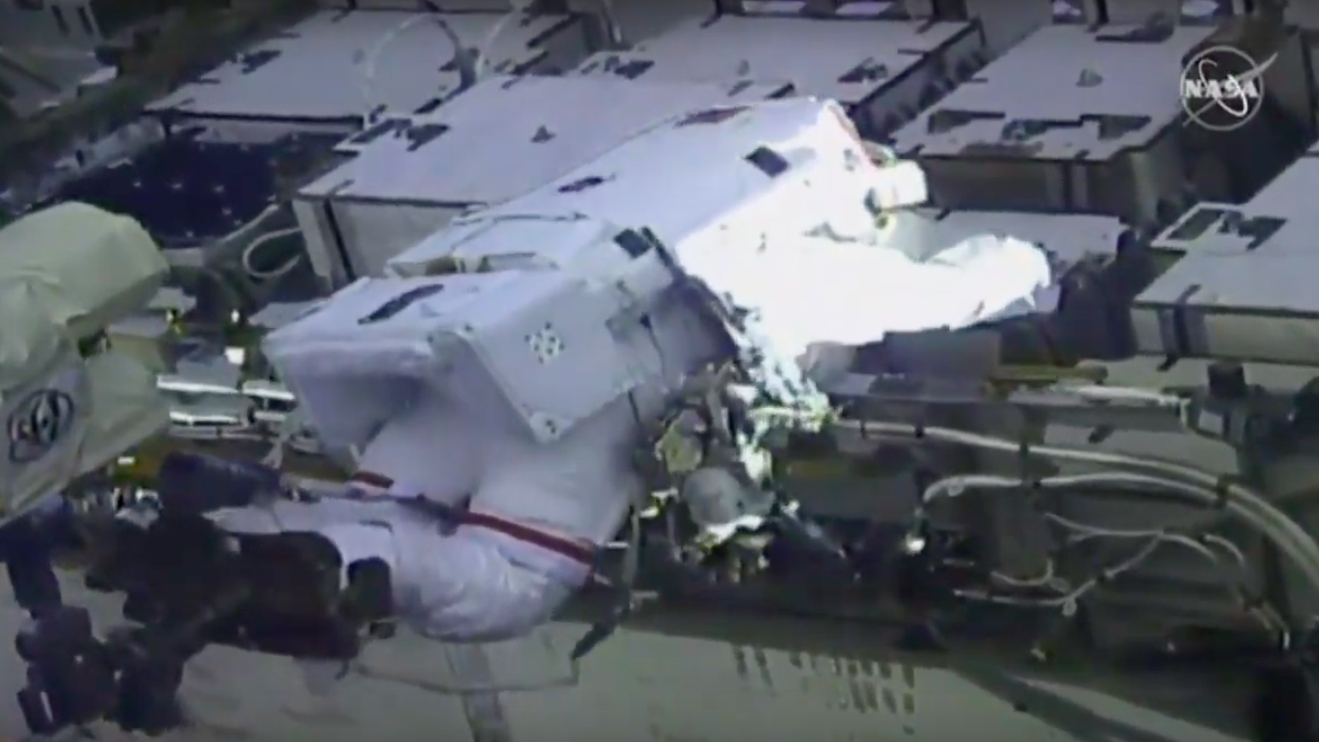 A NASA astronaut works in daylight on the outside of the international space station