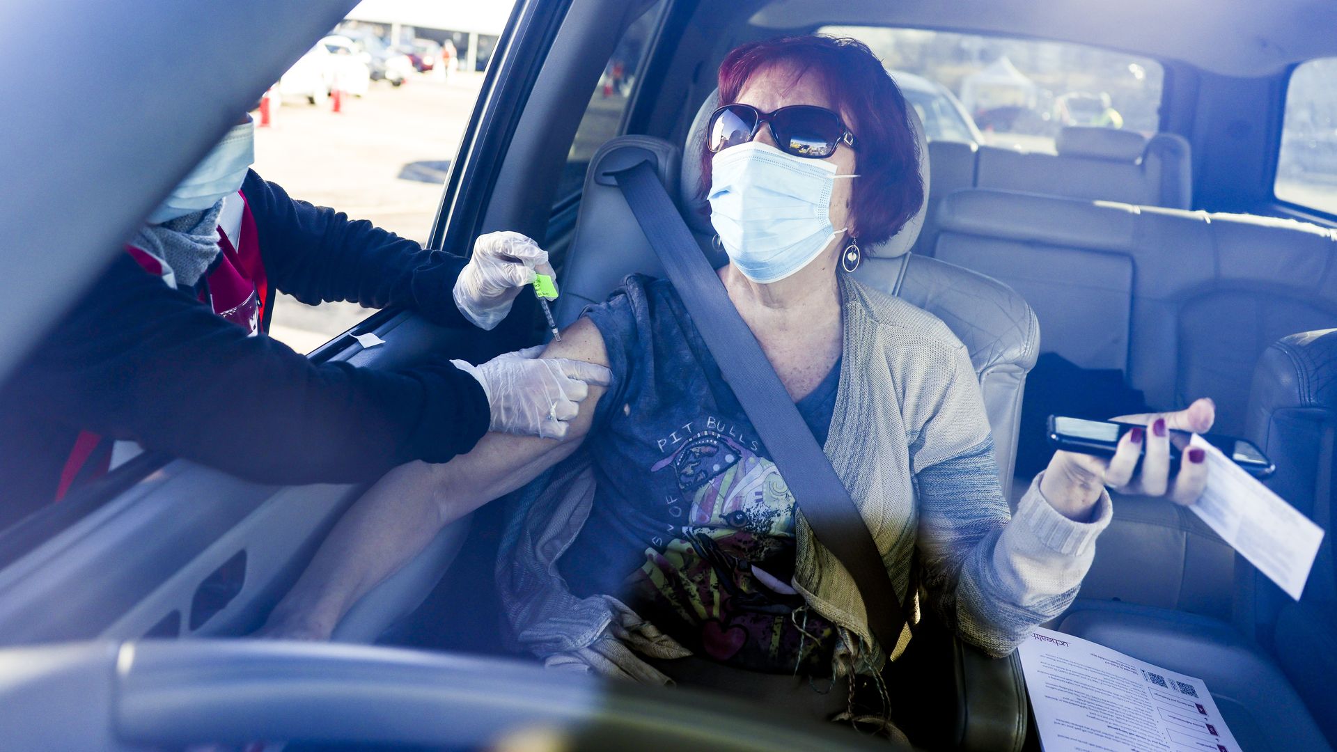 Ambika Nansell receives a dose of the Pfizer-BioNTech vaccine at a mass COVID-19 vaccination event in Denver. 