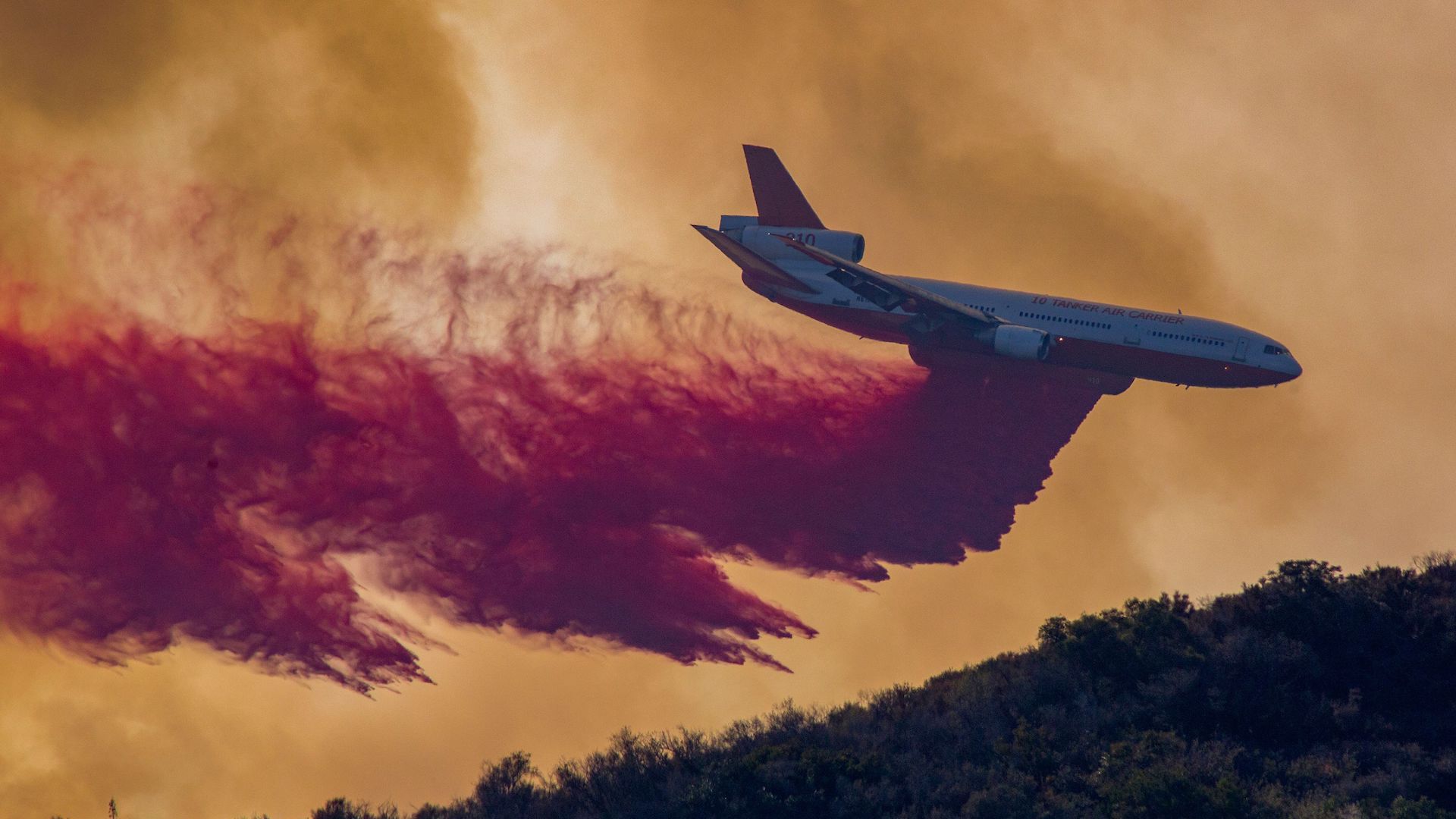 A DC-10 air tanker drops fire retardant on a California wildfire in August 2018.