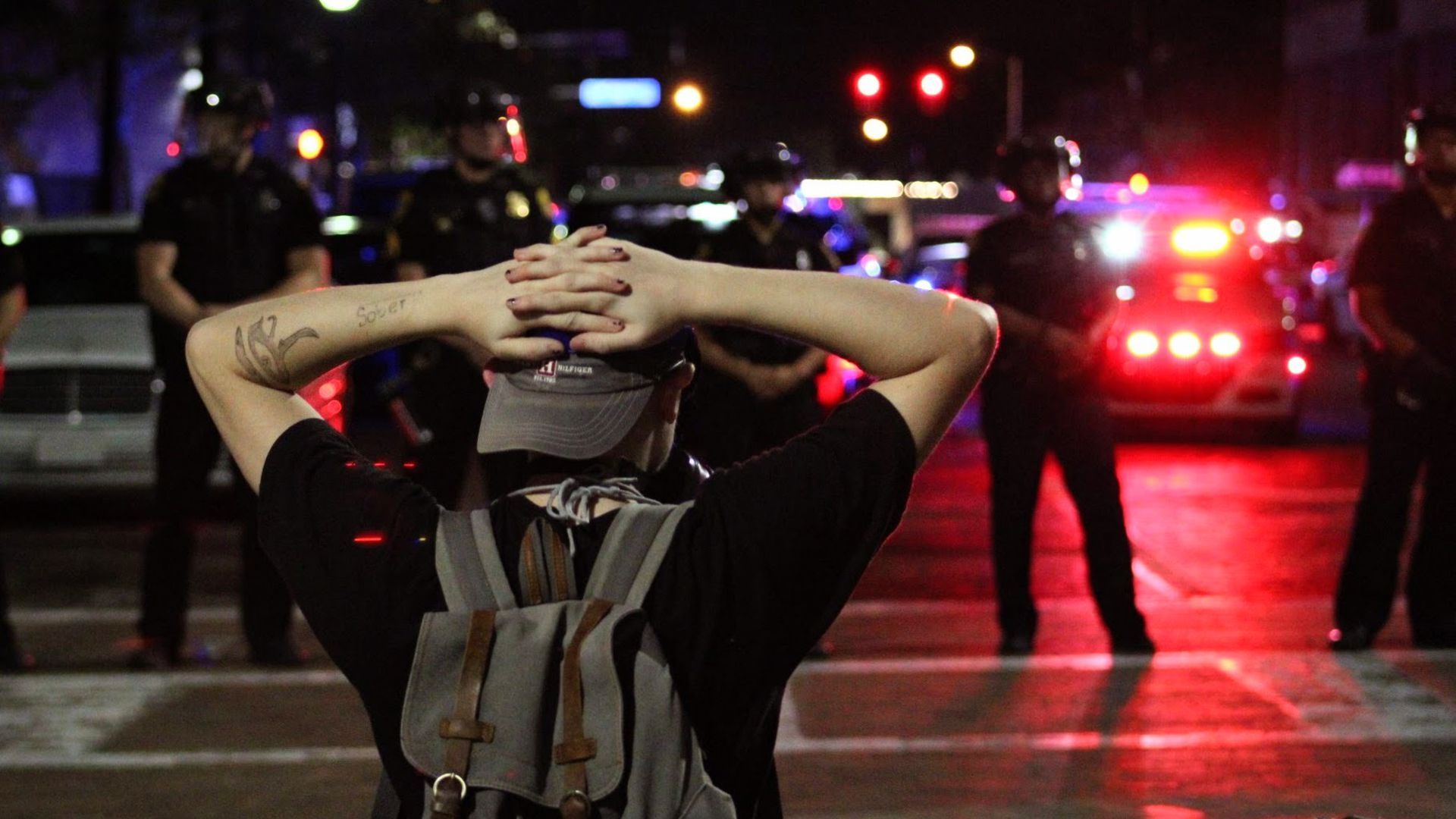A Black Lives Matter protester kneels before Tampa police officers in June. Photo by Gianna Settimi for Axios