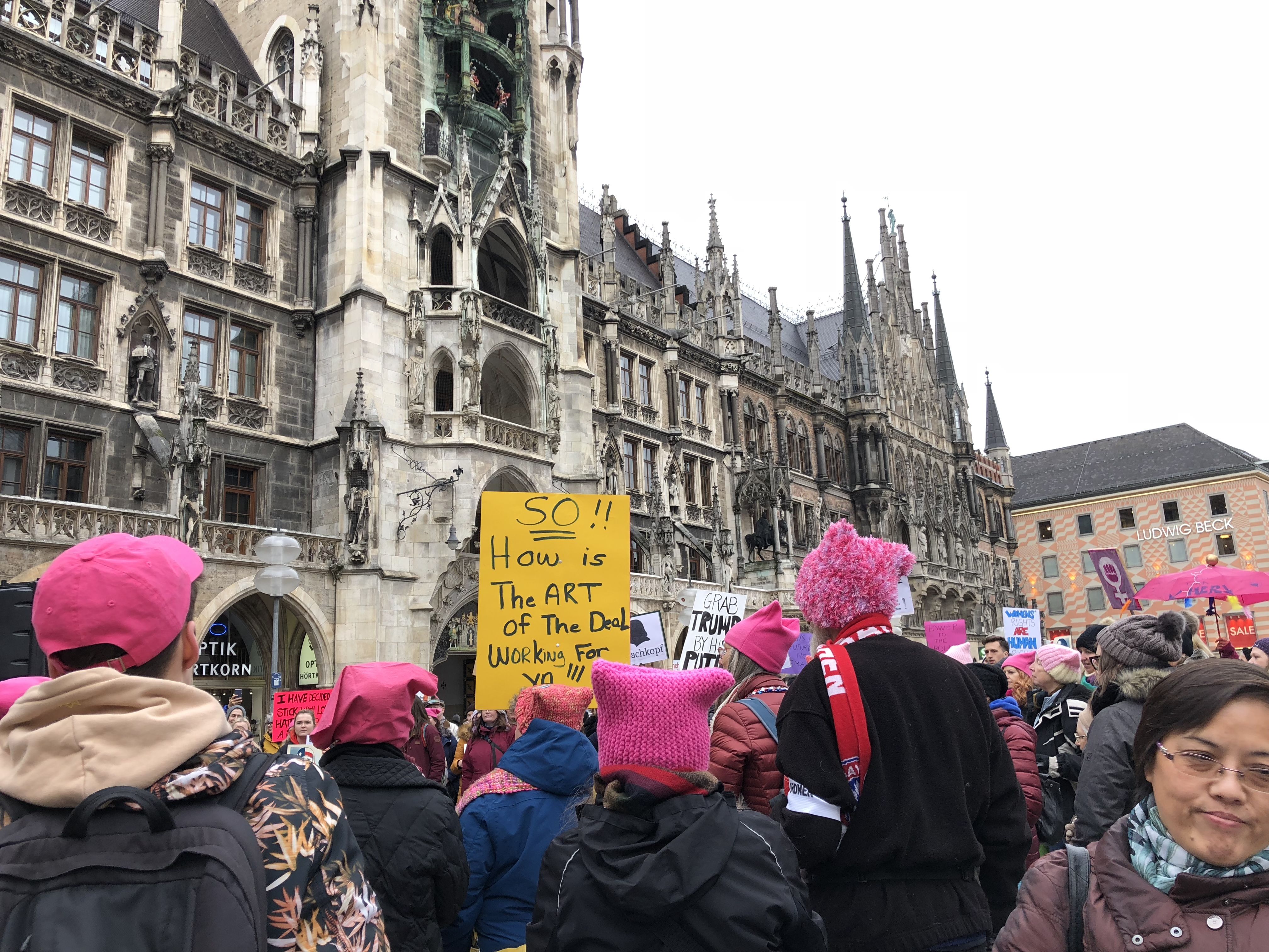 Dozens of people marched in Munich to the central Marienplatz carrying signs wearing pink hats and singing “this land is your land." 