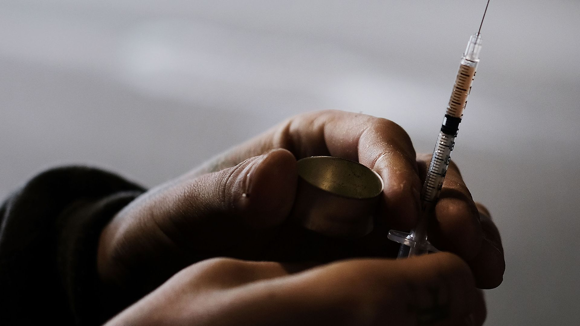 A man uses heroin.