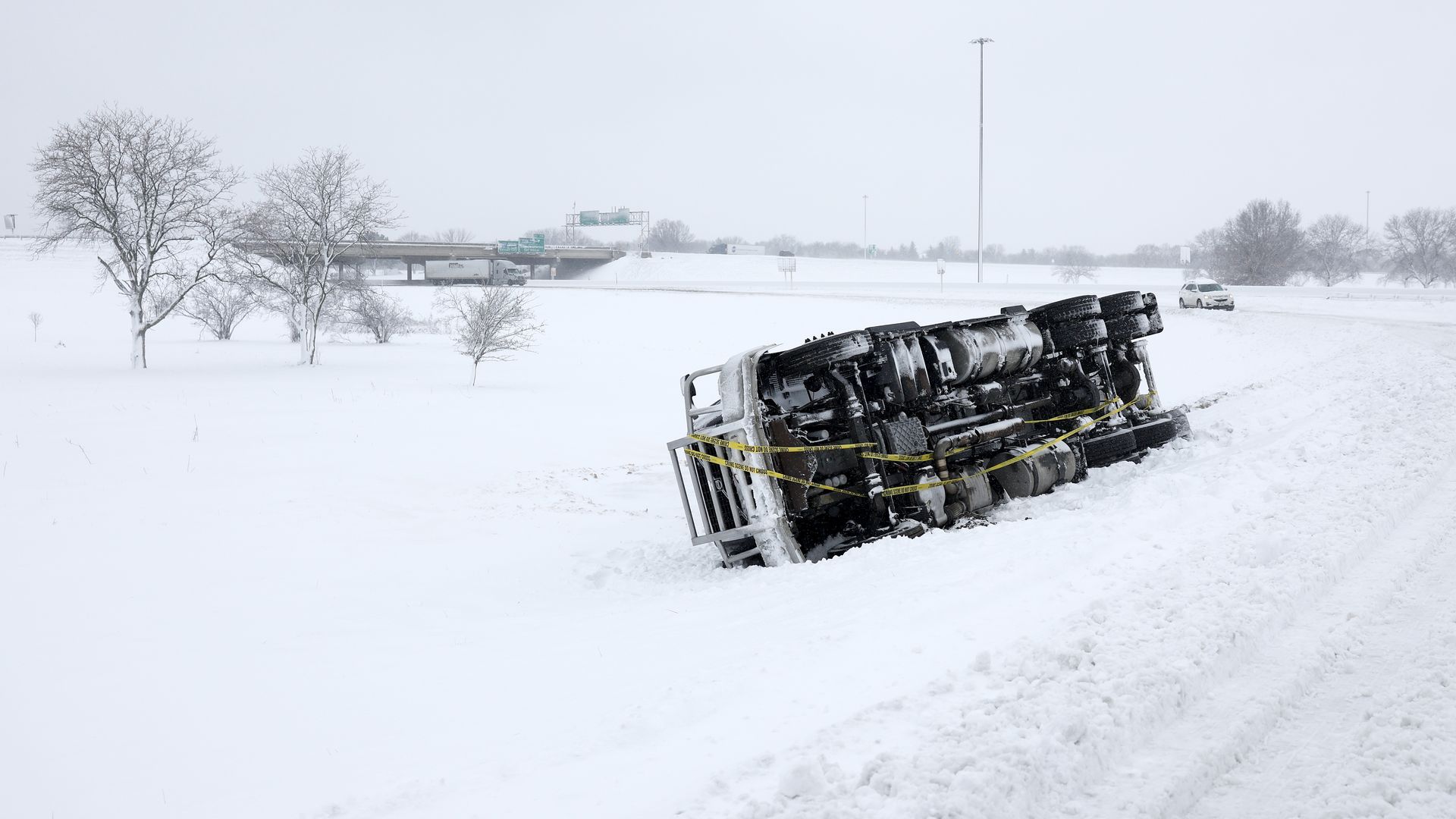 A semi-truck toppled over on the side of a road amidst a snowstorm in Des Moines, Iowa, on Jan. 9.
