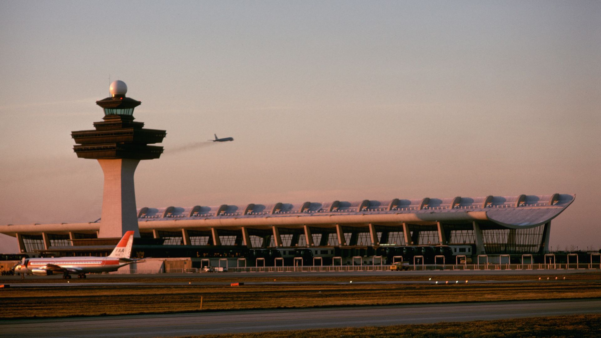 A plane takes off behind the terminal at the Dulles International Airport, which was designed by the Finnish-American architect Eero Saarinen. (Photo by Dean Conger/Corbis via Getty Images)