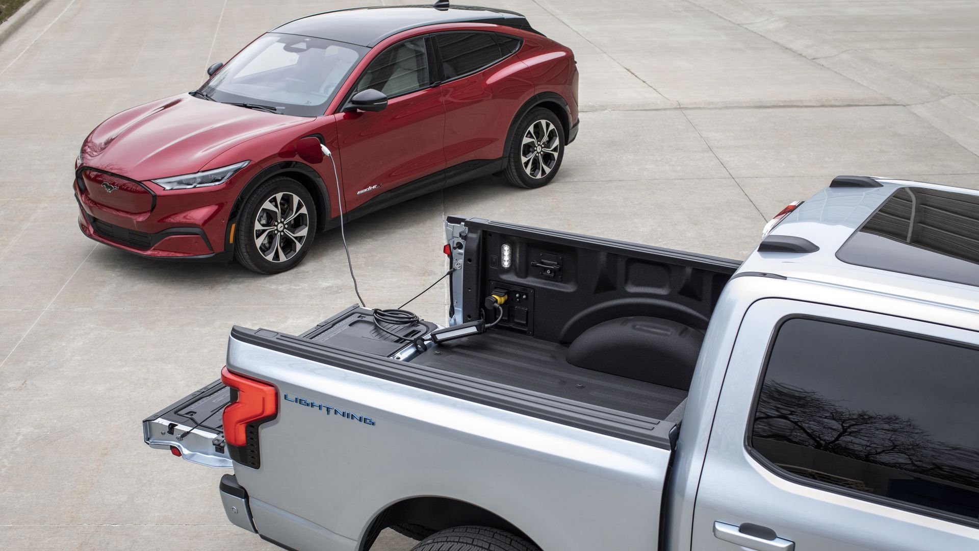 Ford's F-150 Lightning pickup topping off the battery in a Mustang Mach-E