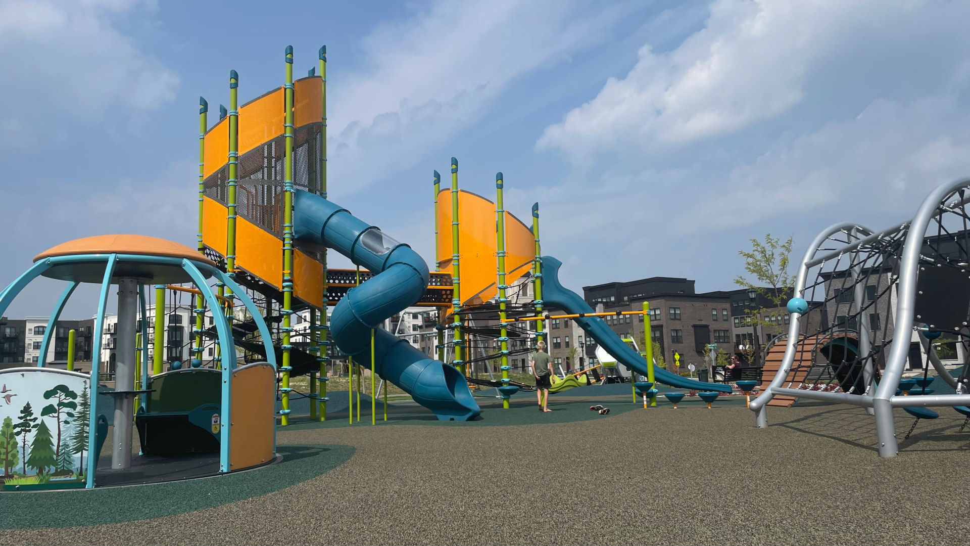 blue and orange playground with slides and climbing structure