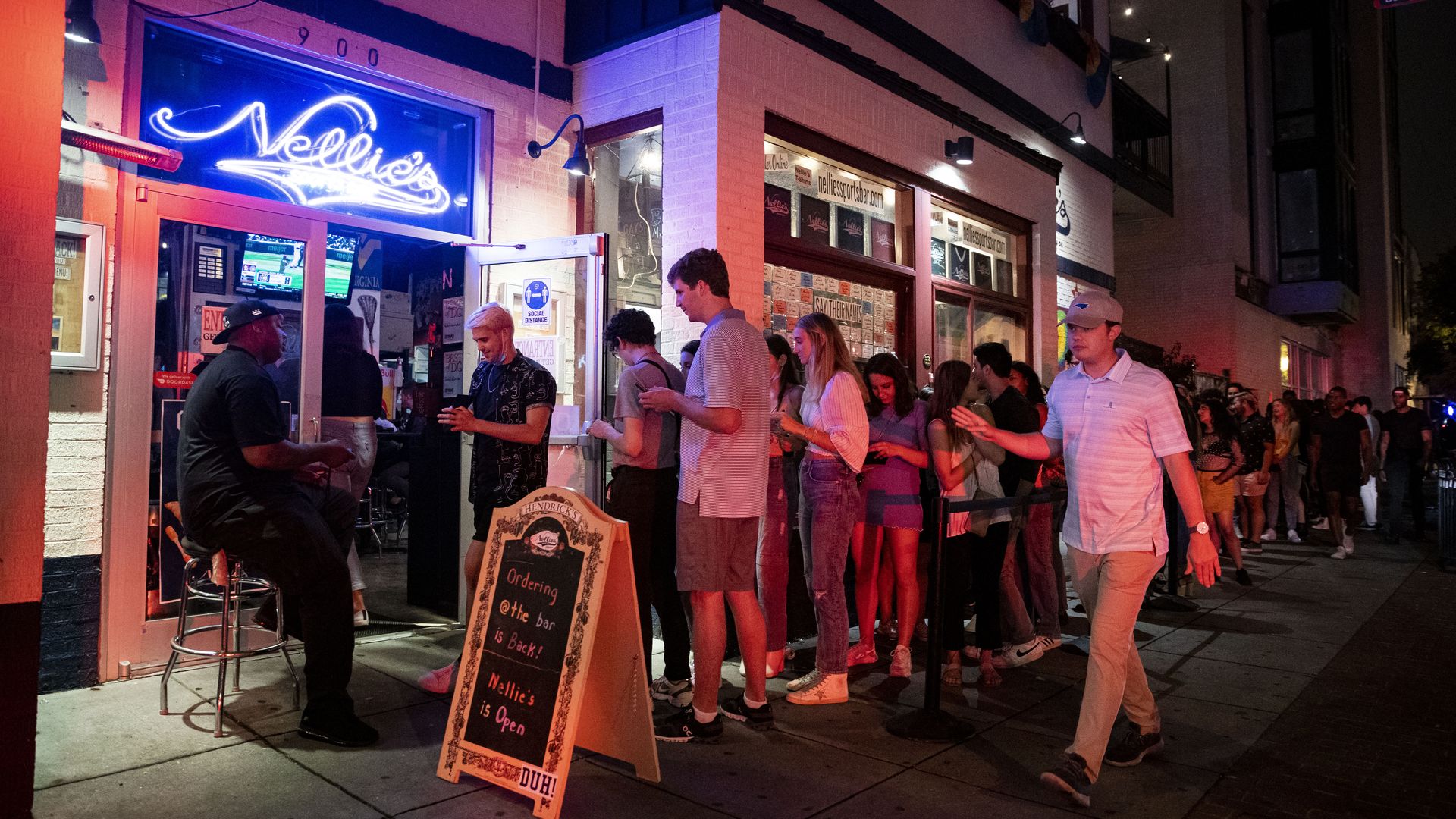 Patrons wait in line outside of a D.C. bar.