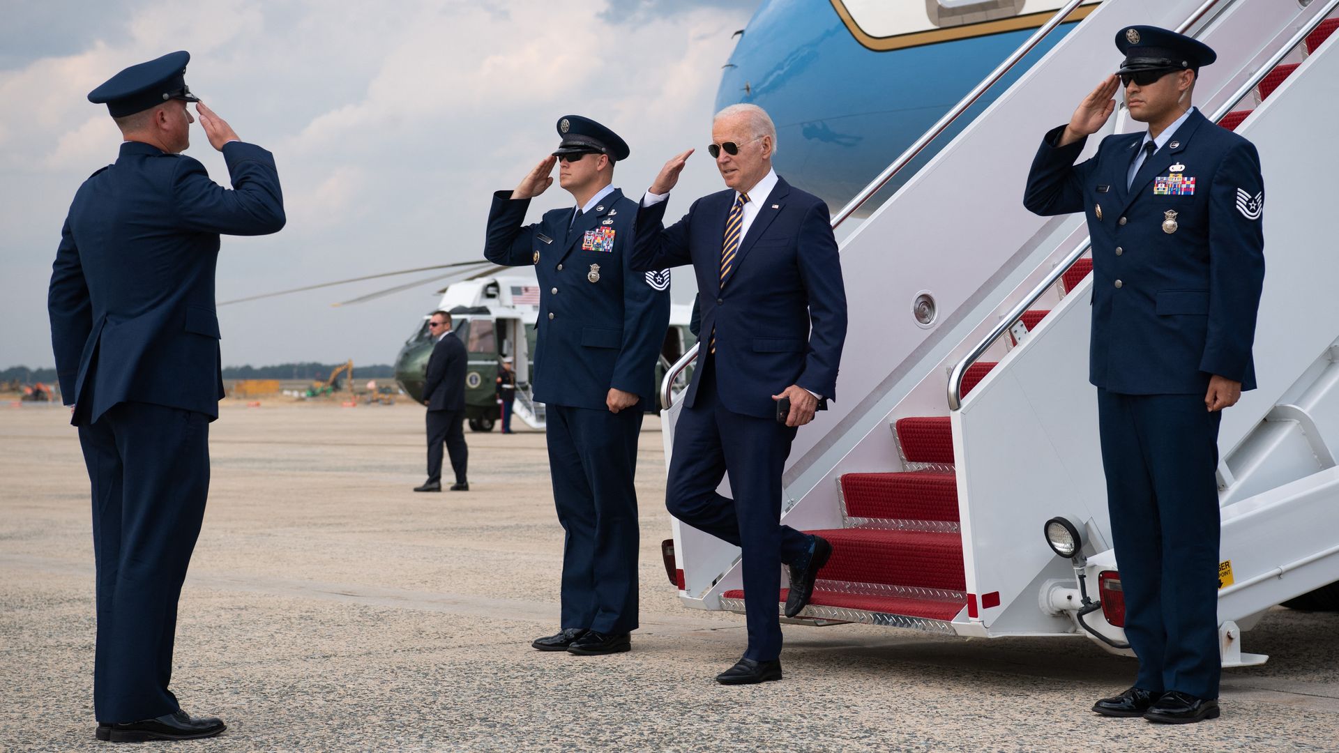 President Biden is seen returning the salutes of members of the Air Force after arriving back at Joint Base Andrews.