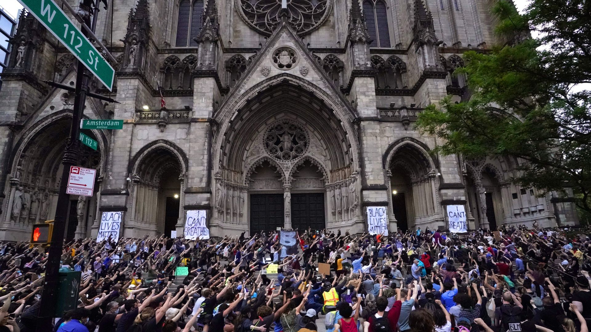 A crowd is seen outside a New York City church last summer protesting the death of George Floyd.