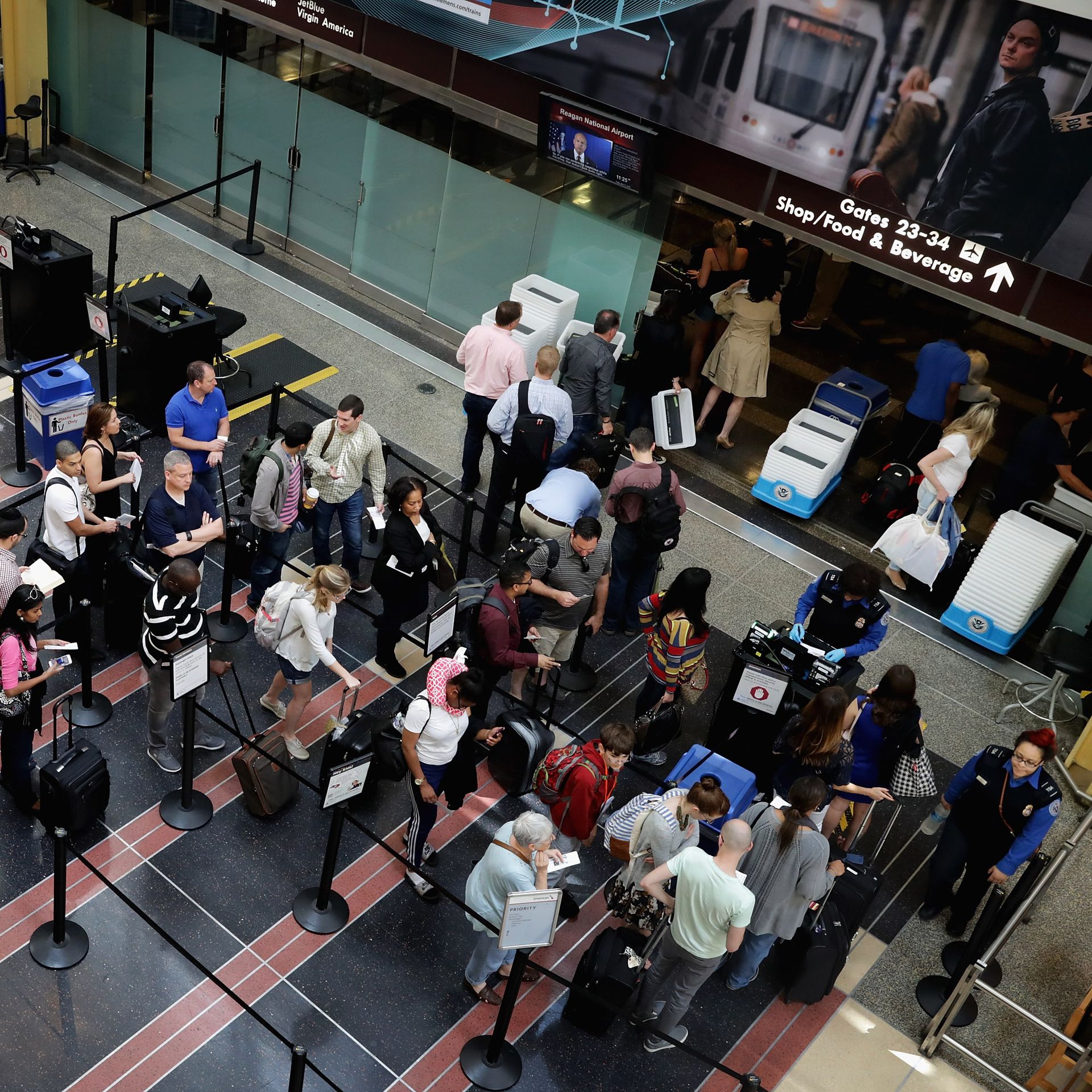 Passengers queue up outside a Transportation Security Administration checkpoint at Ronald Reagan National Airport