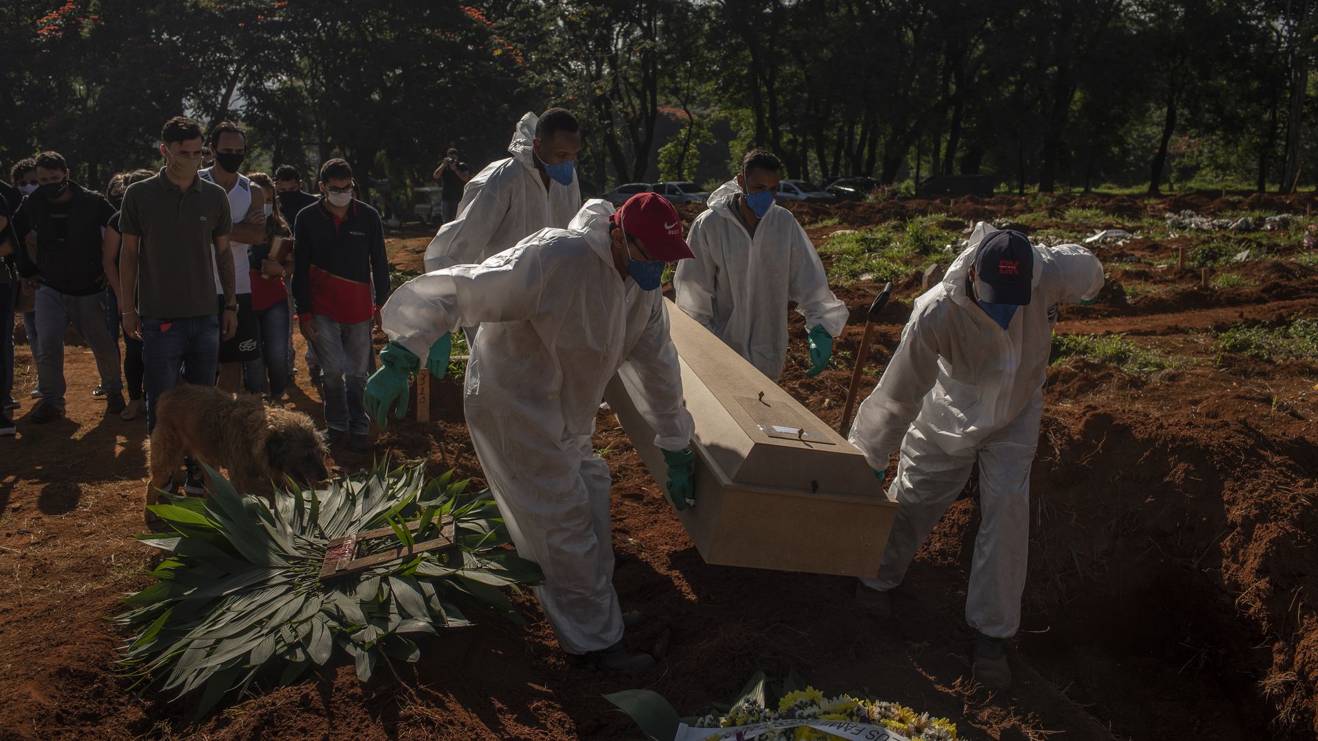 Mourners watch as workers wearing protective equipment bury the casket of a Covid-19 victim at the Vila Formosa cemetery in Sao Paulo, Brazil.
