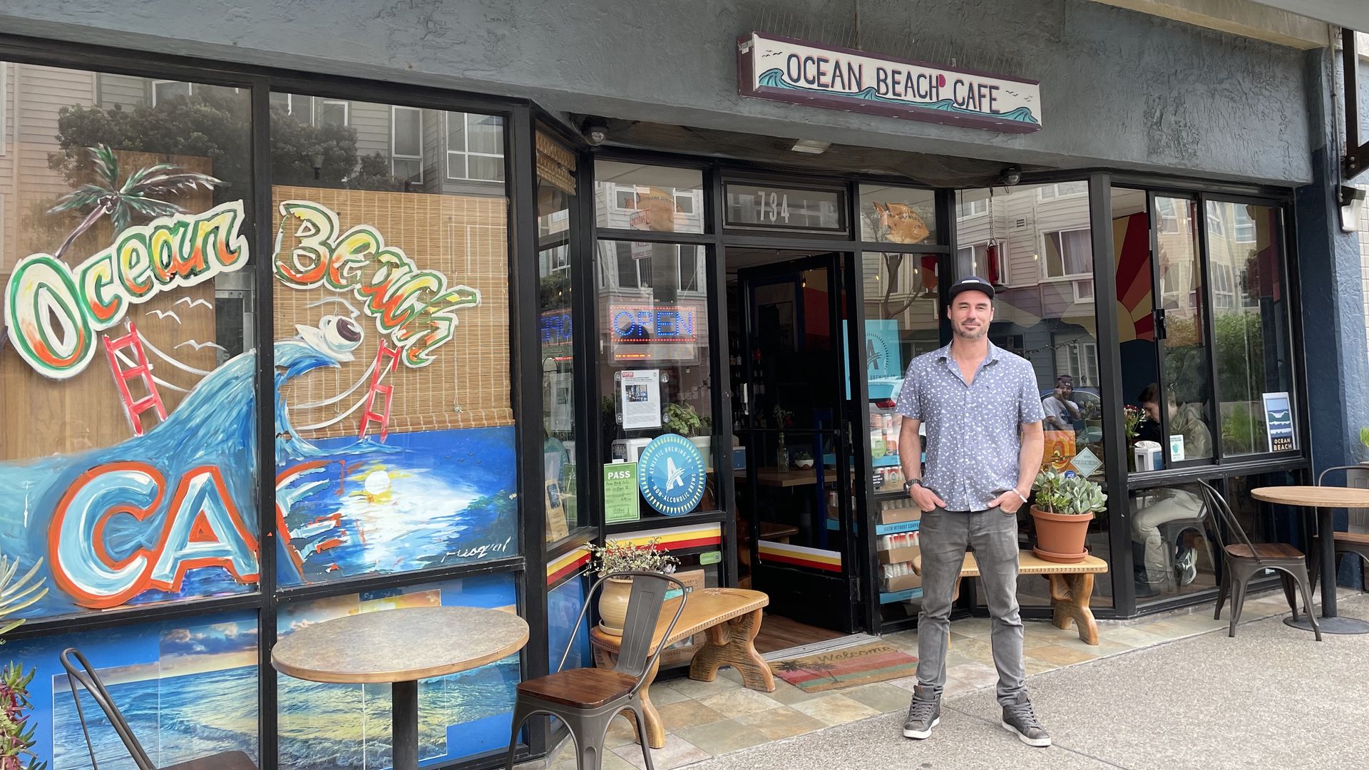 Man wearing a baseball cap with hands in pocket.