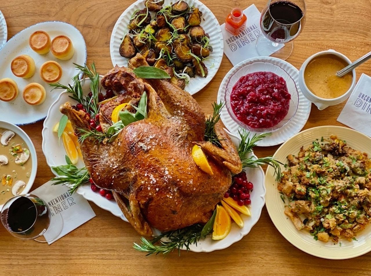 A Thanksgiving table with turkey and sides at Unconventional Diner 