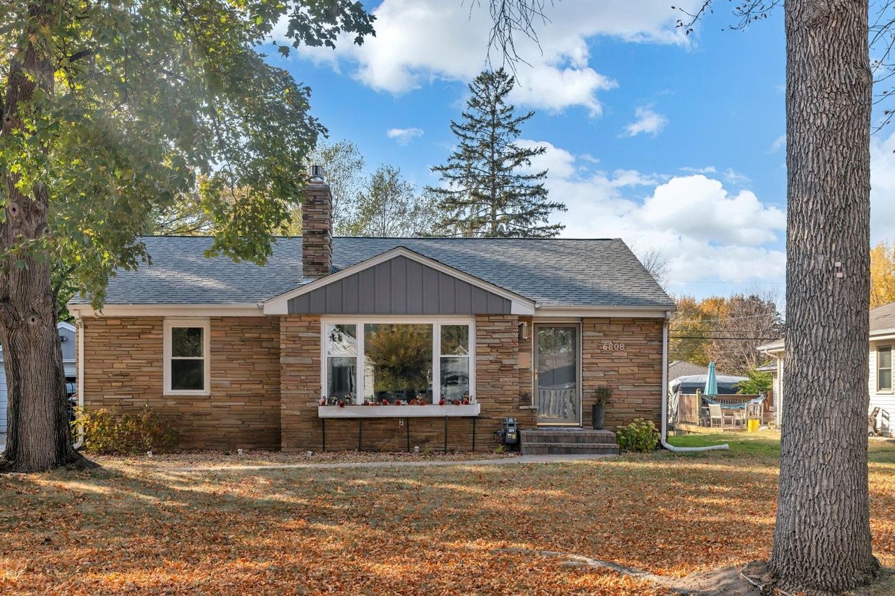 exterior of home with stone facade and chimney