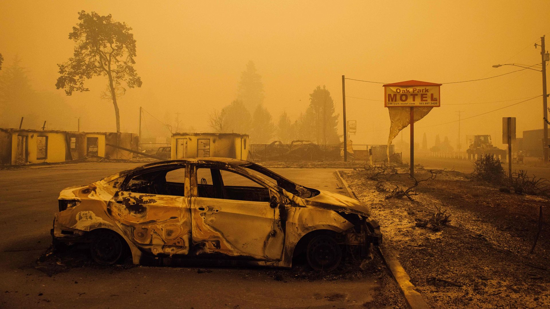 A charred vehicle is seen in the parking lot of the burned Oak Park Motel after the passage of the Santiam Fire in Gates, Oregon, on September 10, 2020. 