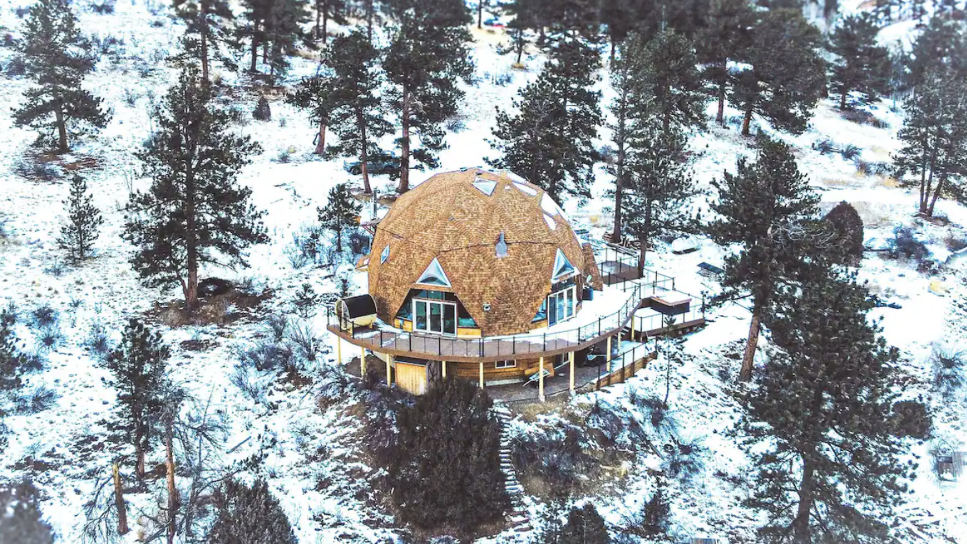 snowy mountainside with a dome structure