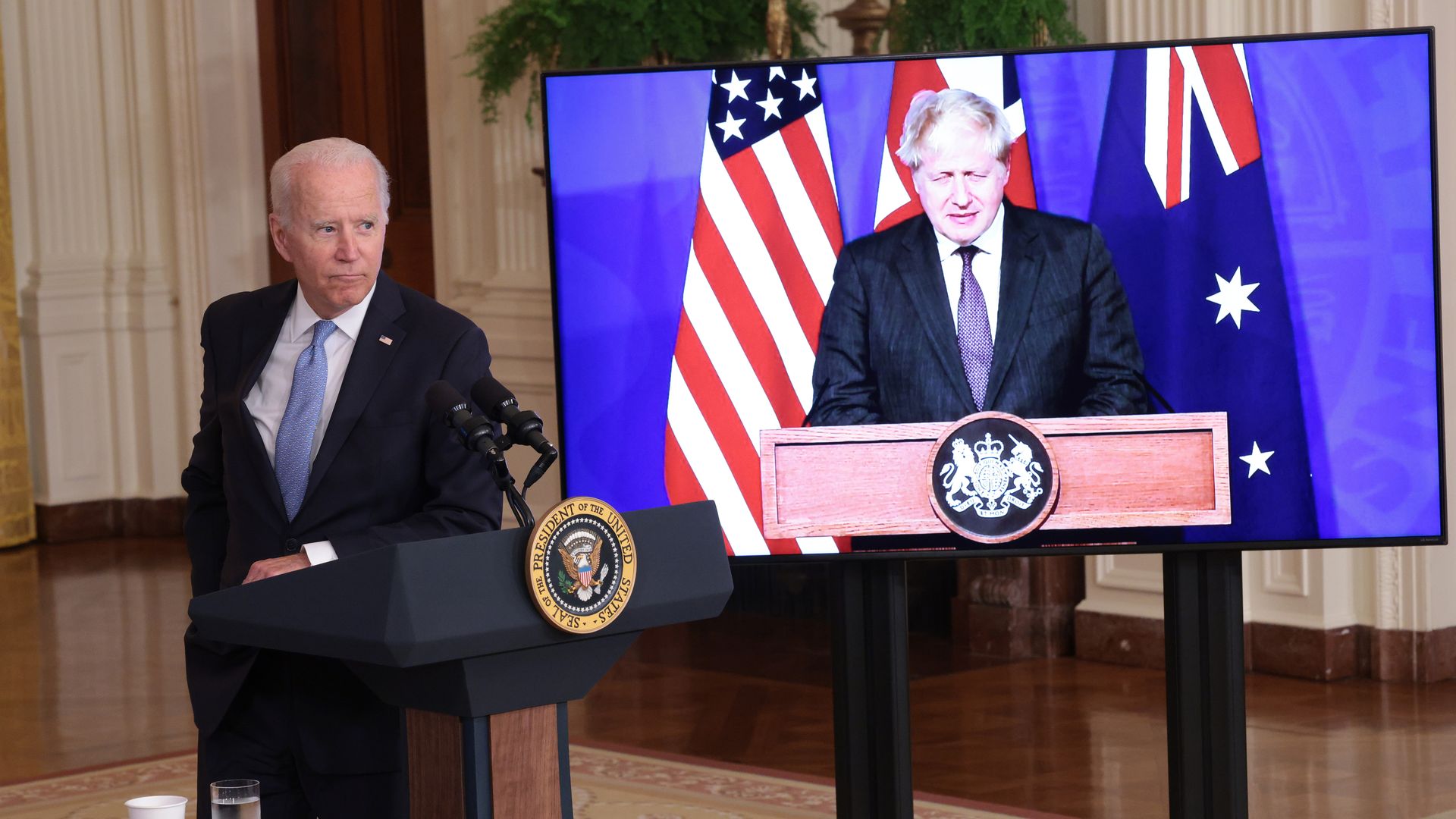 Biden at the White House, leaning into a lectern