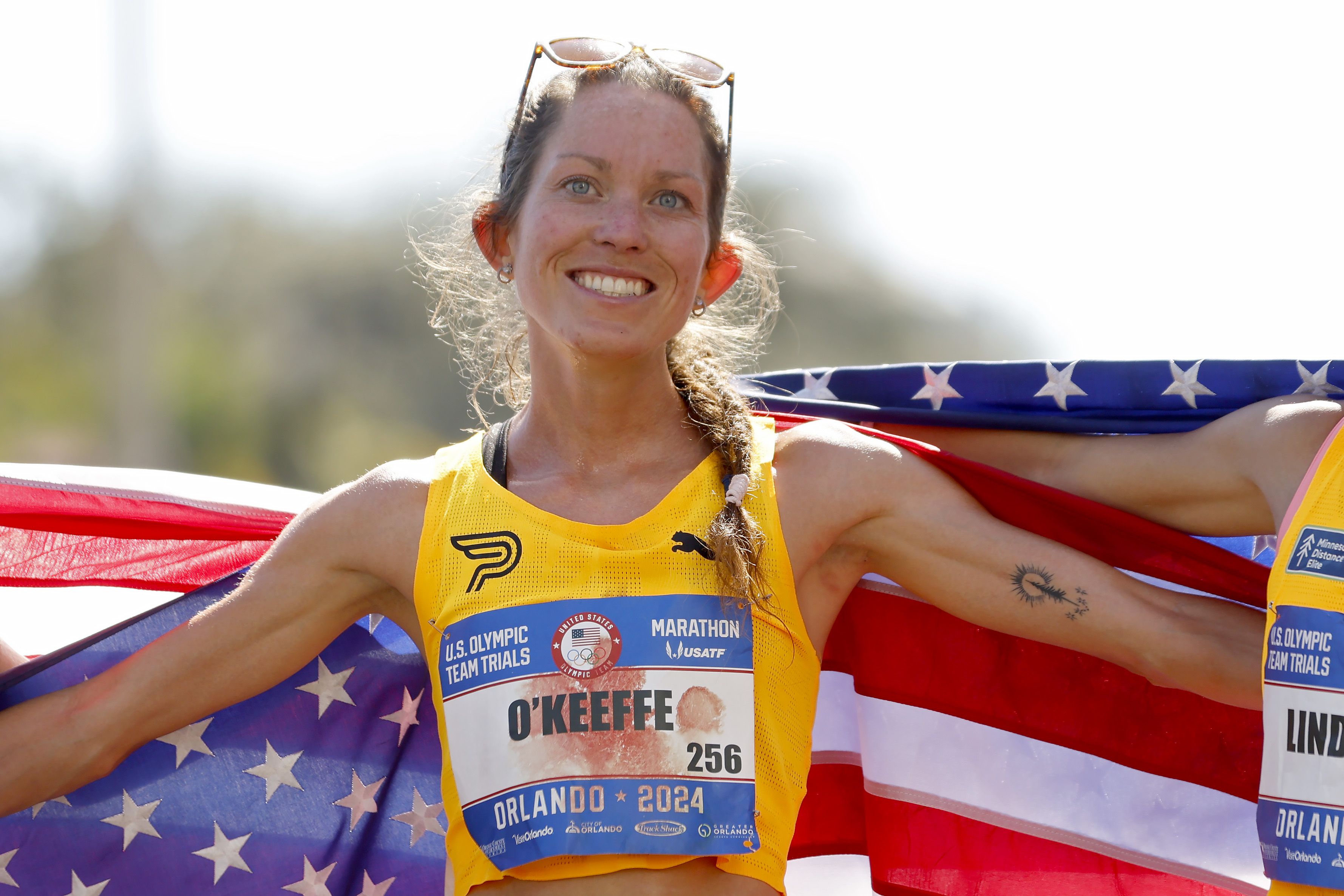 Fiona O'Keefe celebrates with an American flag draped around her.