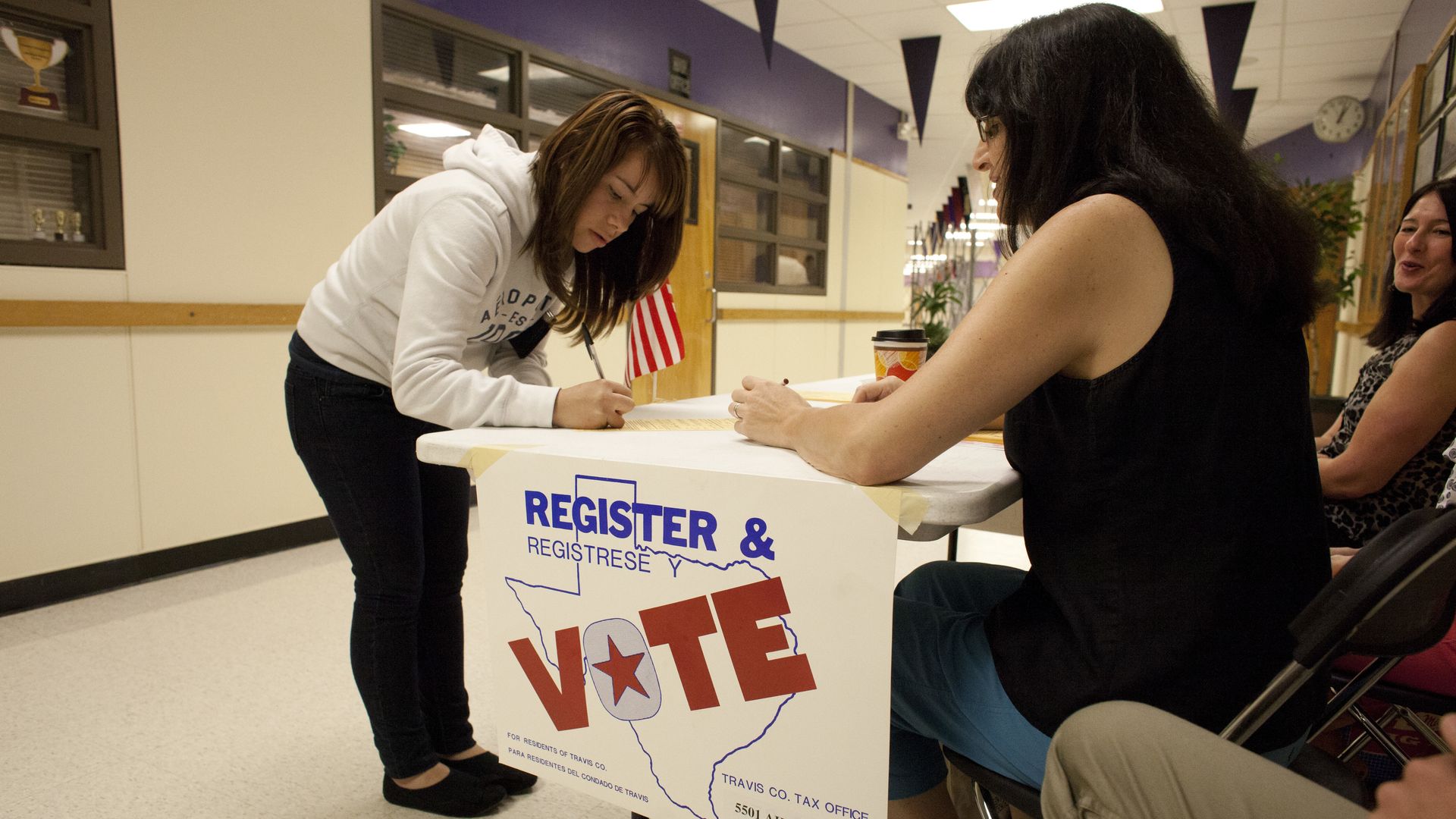 A high school student registers to vote in a high school in Austin.