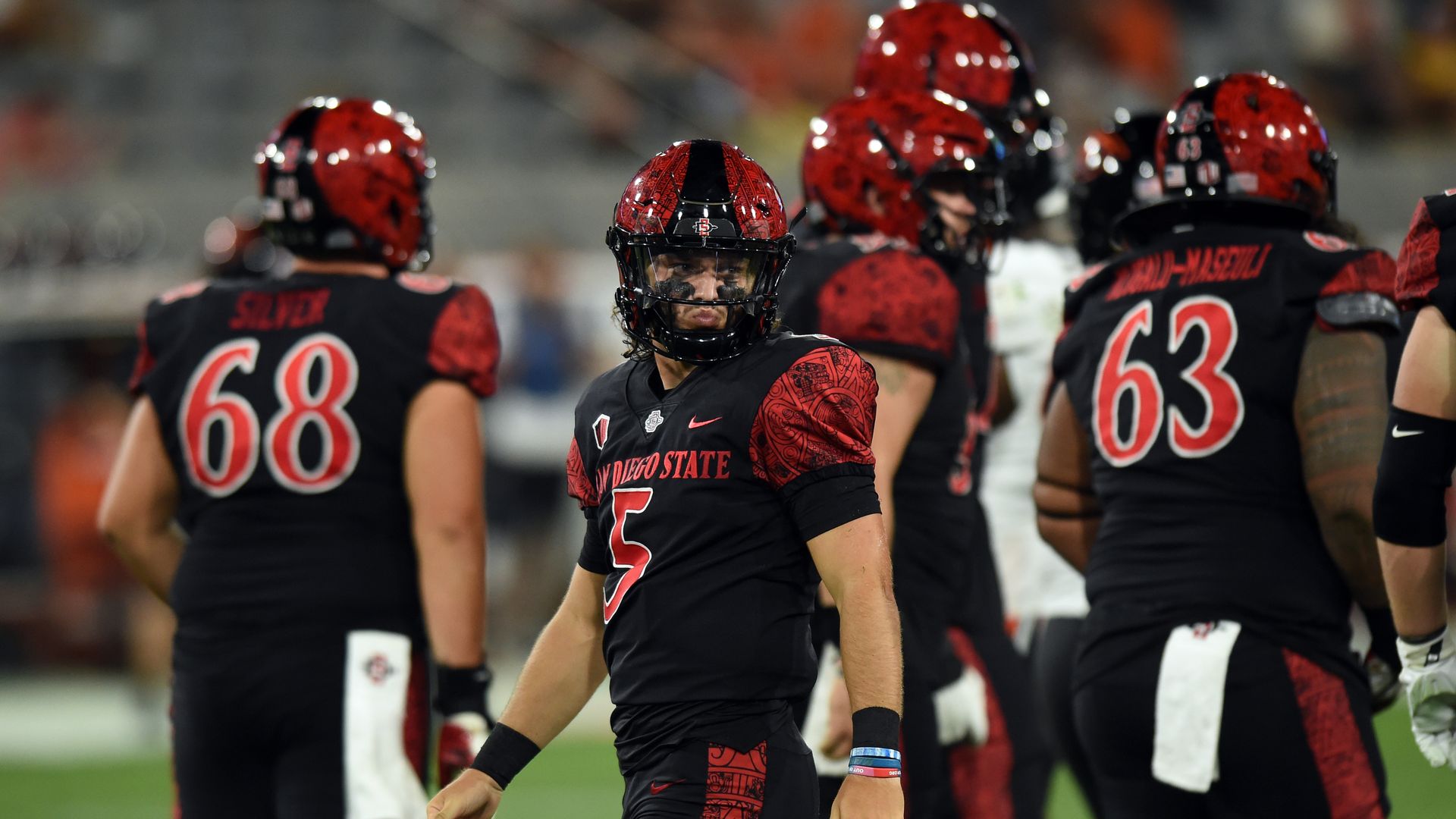A football team in black and red with San Diego State on the uniforms