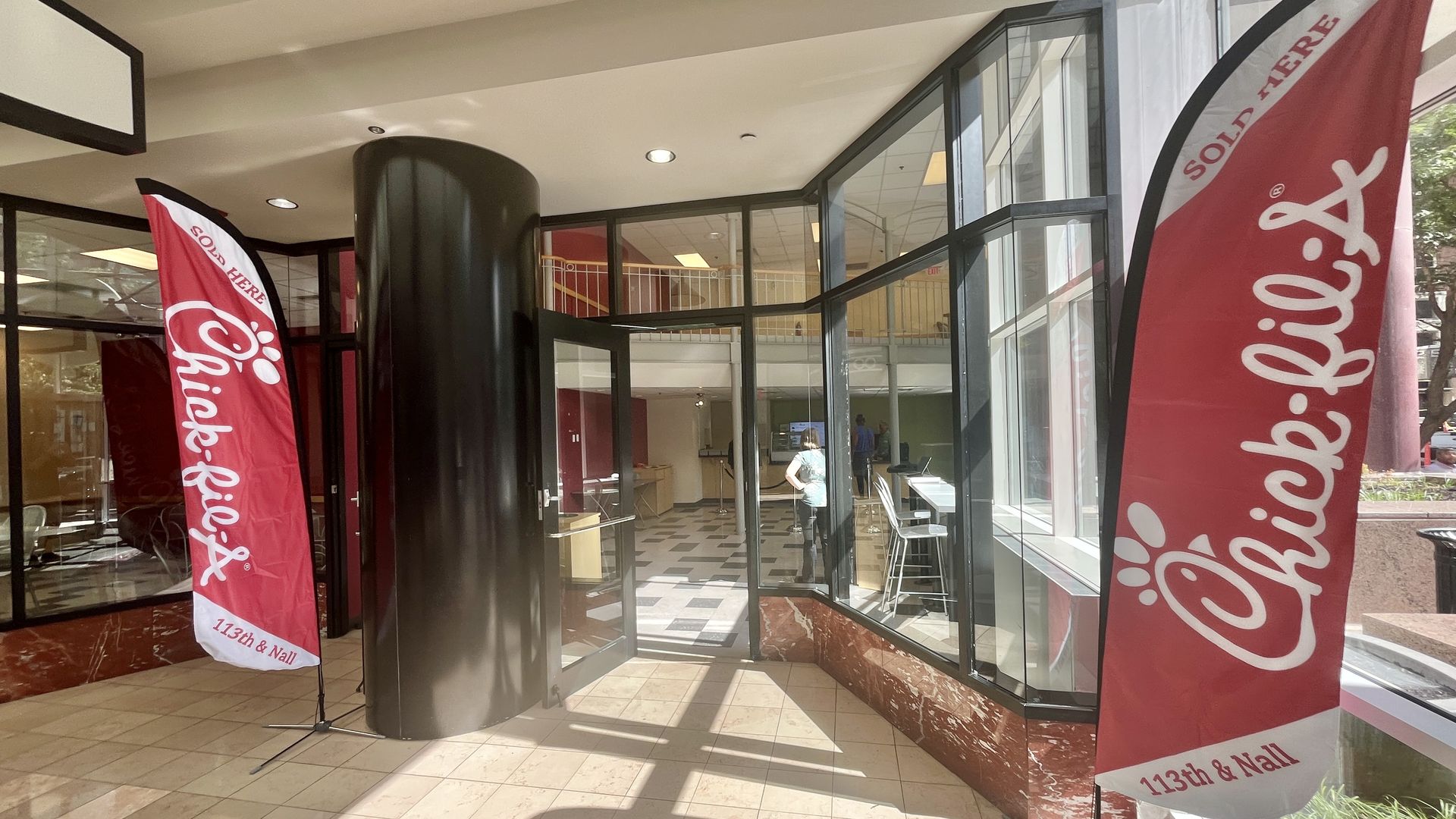 Chick-fil-A banners stand on either side of a retail store entrance within Commerce Bank tower.