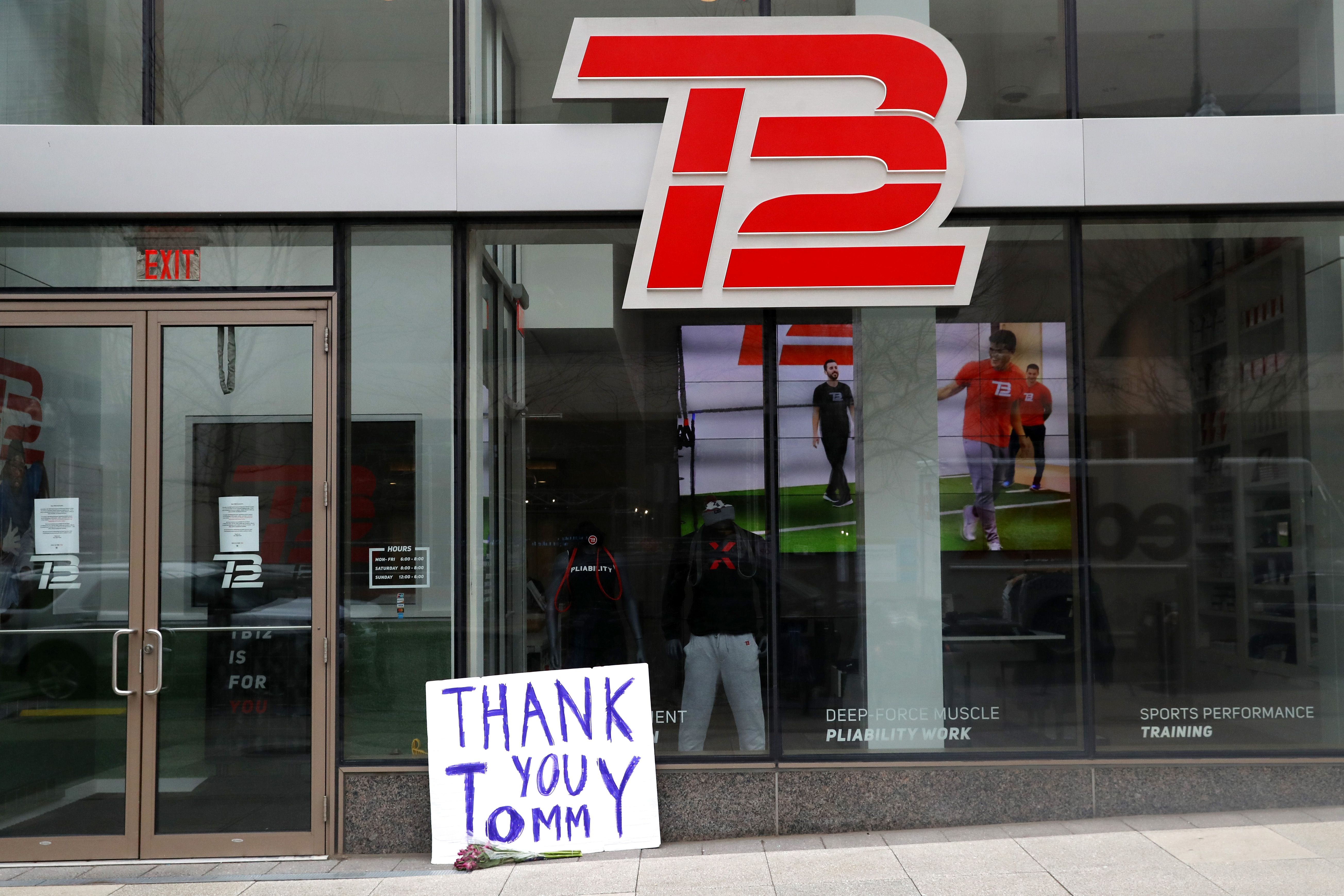 "Thank you Tommy" sign with flowers